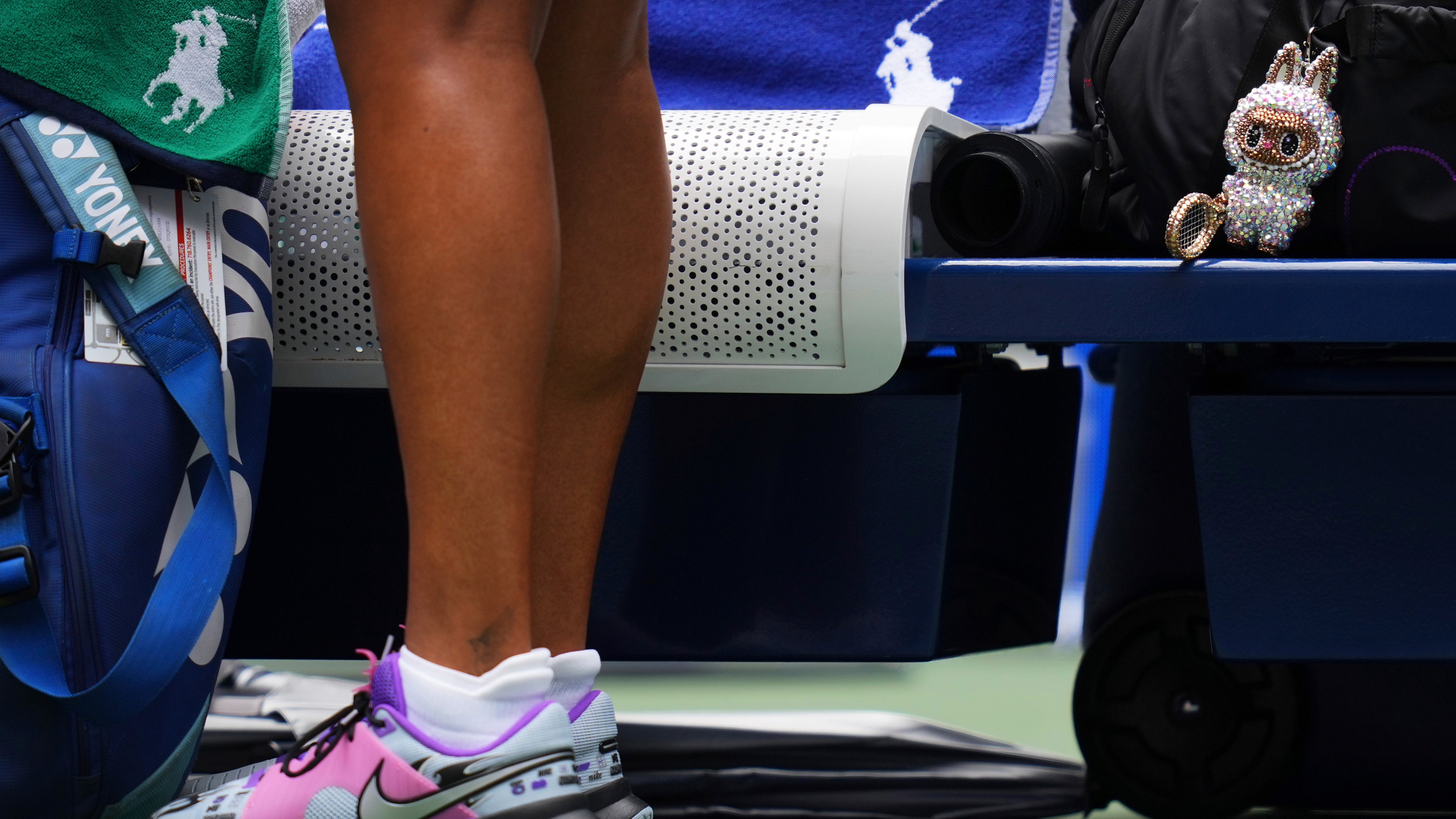 A Labubu doll sits near Naomi Osaka, of Japan, before her match against Coco Gauff, of the United States, during the fourth round of the US Open tennis championships, Monday, Sept. 1, 2025, in New York.