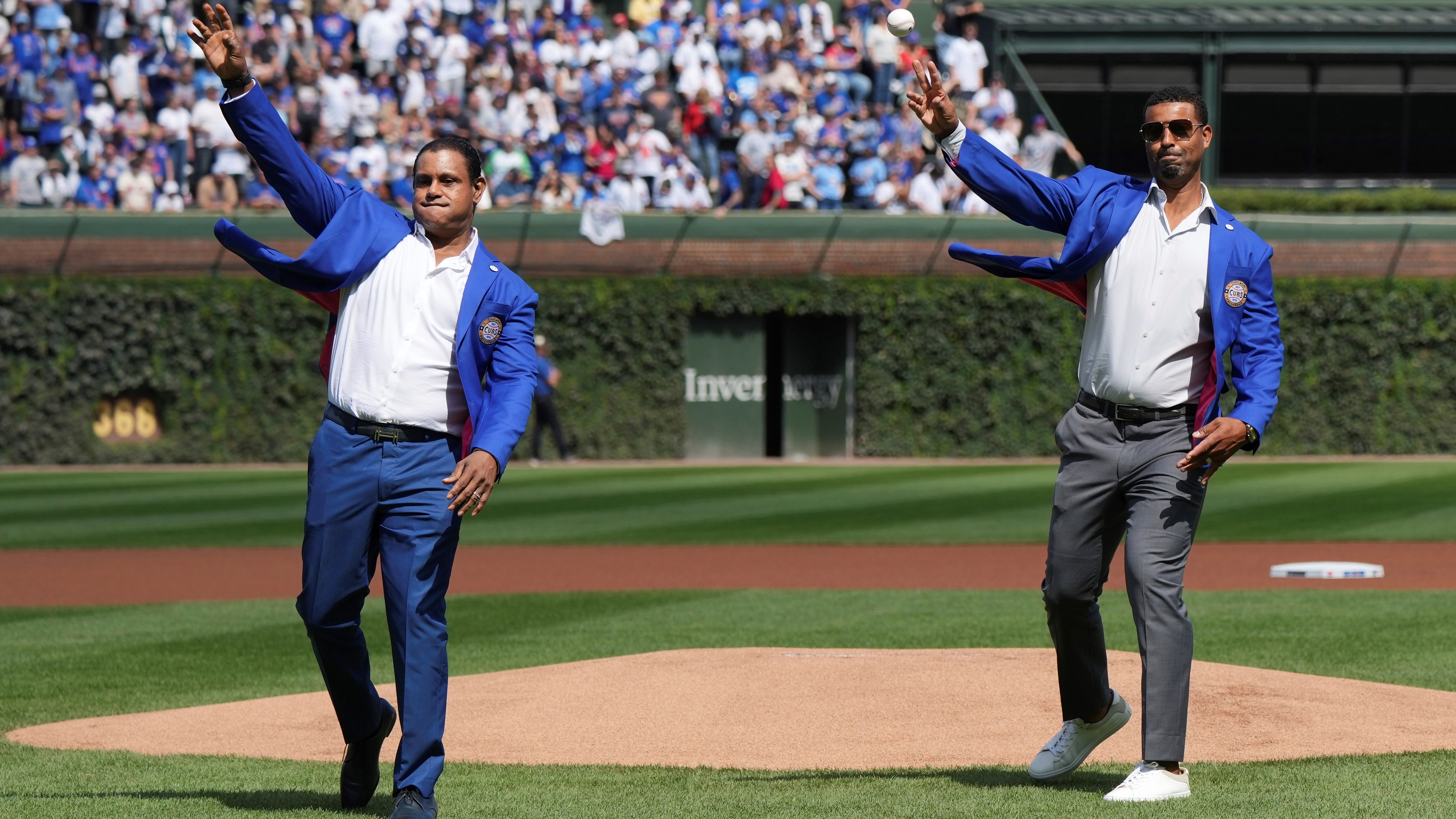 Former Chicago Cubs players Sammy Sosa and Derrek Lee throw out the ceremonial first pitch before a Chicago Cubs baseball game at Wrigley Field, Sunday, Sept. 7, 2025.