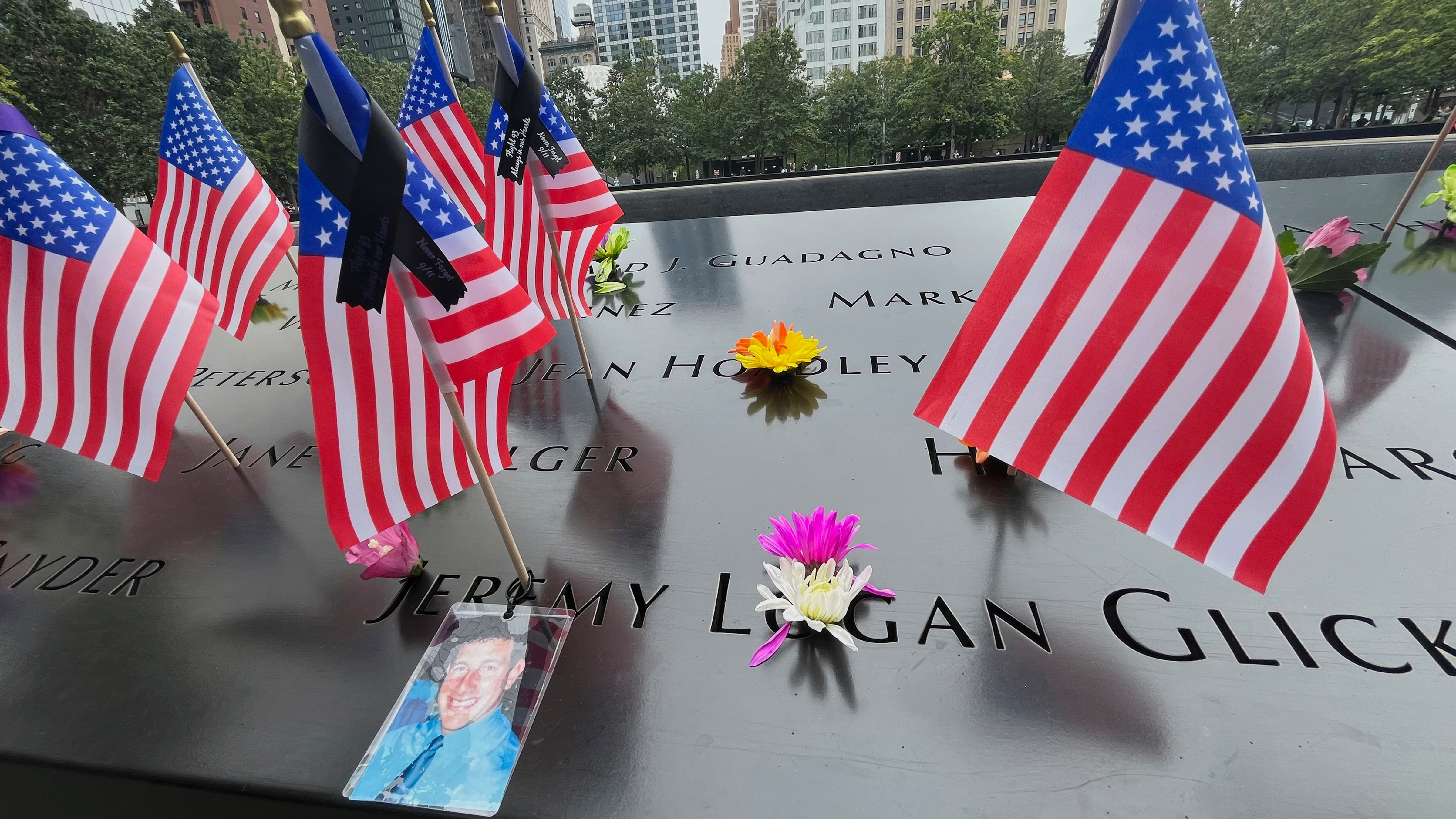 Flags and flowers are placed in the inscribed names at the National September 11 Memorial in New York on Wednesday, Sept. 10, 2025.