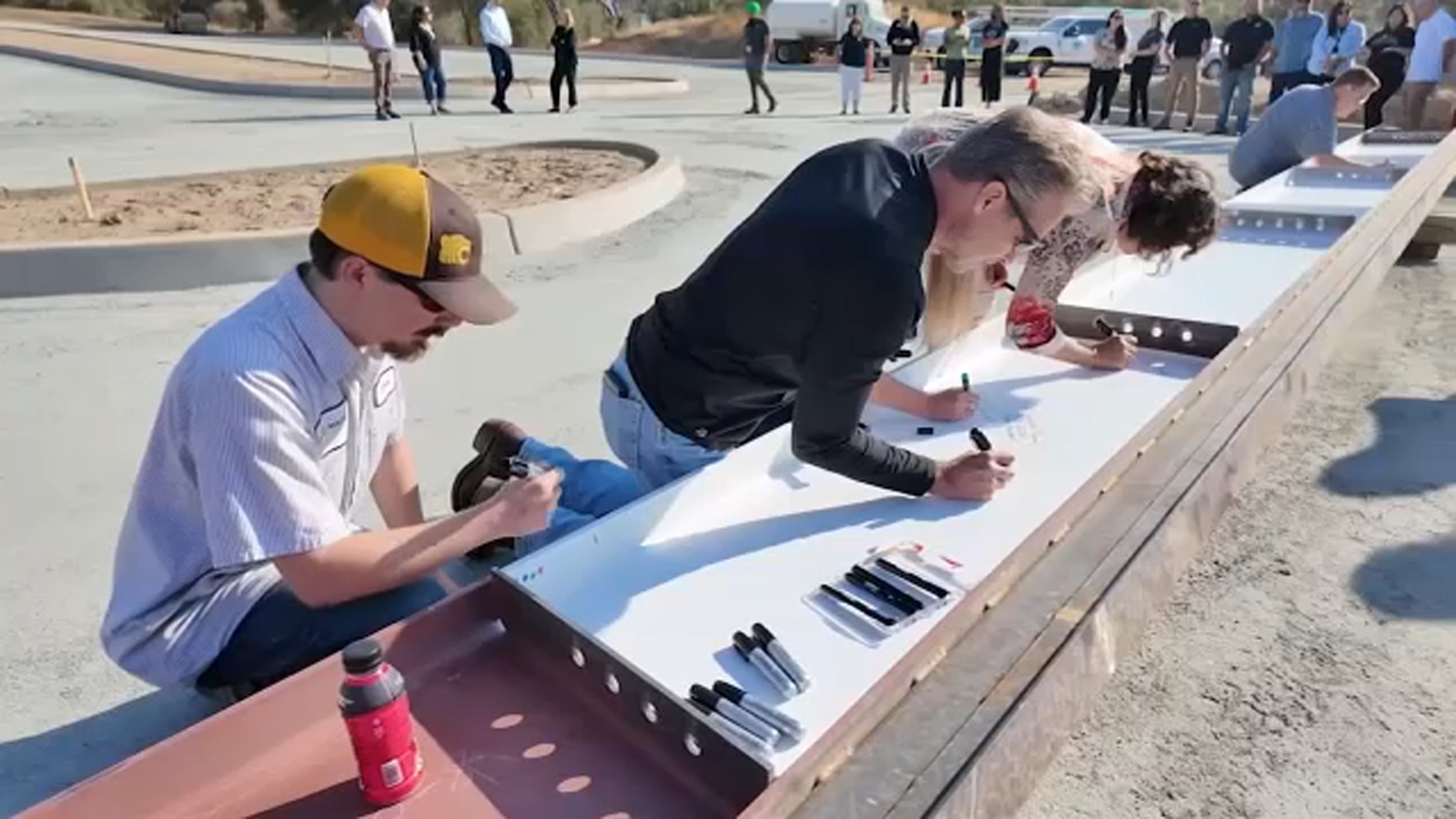 Madera Community College faculty and staff sign steel beam at future Oakhurst campus