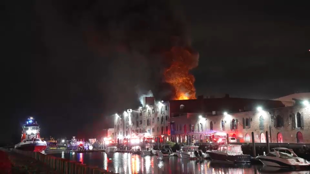 Massive fire destroys artist warehouse, injures 2 firefighters