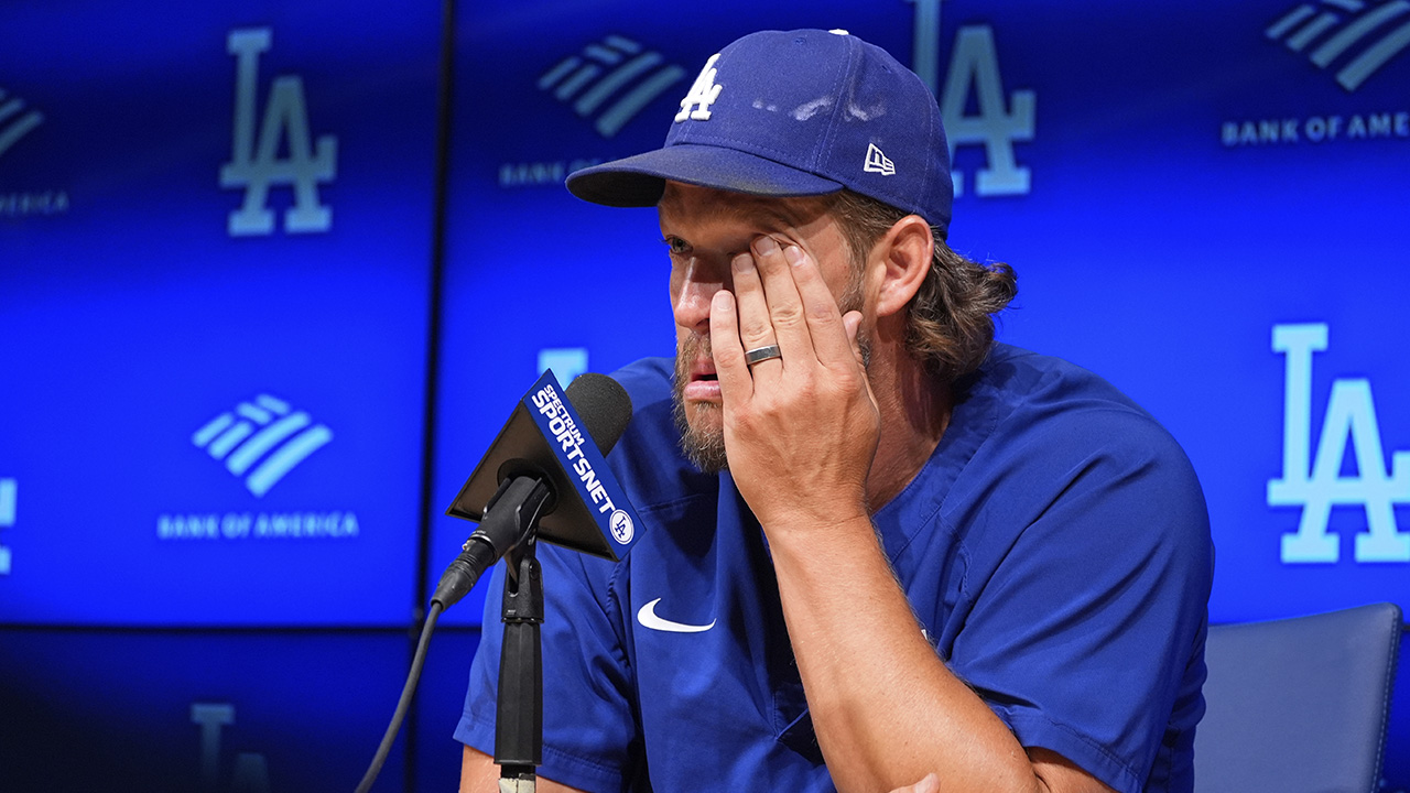 Dodgers pitcher Clayton Kershaw wipes his face as he speaks to the media after announcing his retirement, Sept. 18, 2025.
