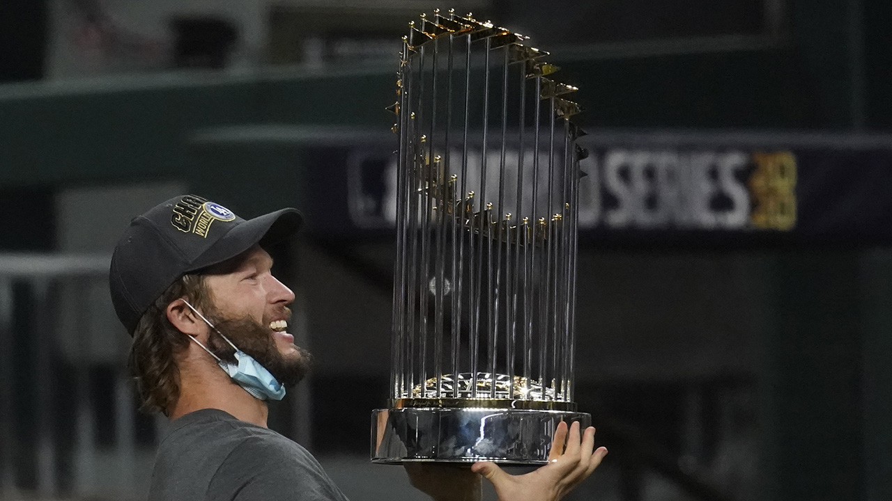 Clayton Kershaw celebrates with the World Series trophy after the Dodgers defeated the Tampa Bay Rays in Game 6 of the series, Tuesday, Oct. 27, 2020, in Arlington, Texas.