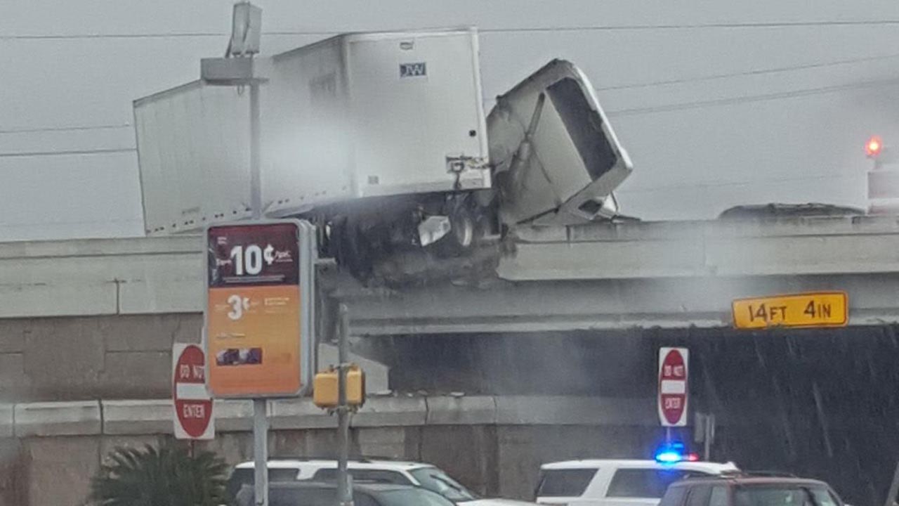 Jackknifed 18-wheeler damages major freeway