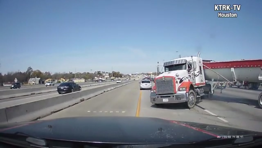 Truck jackknifes, nearly hits other cars