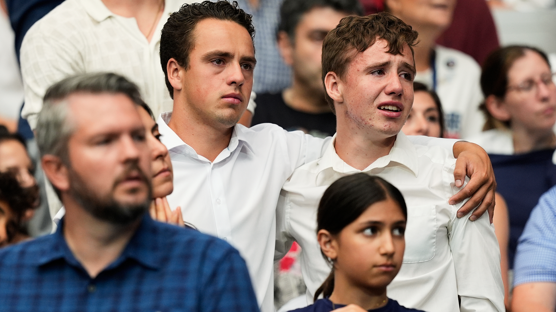 Attendees react during a memorial for conservative activist Charlie Kirk, Sunday, Sept. 21, 2025, at State Farm Stadium in Glendale, Ariz.