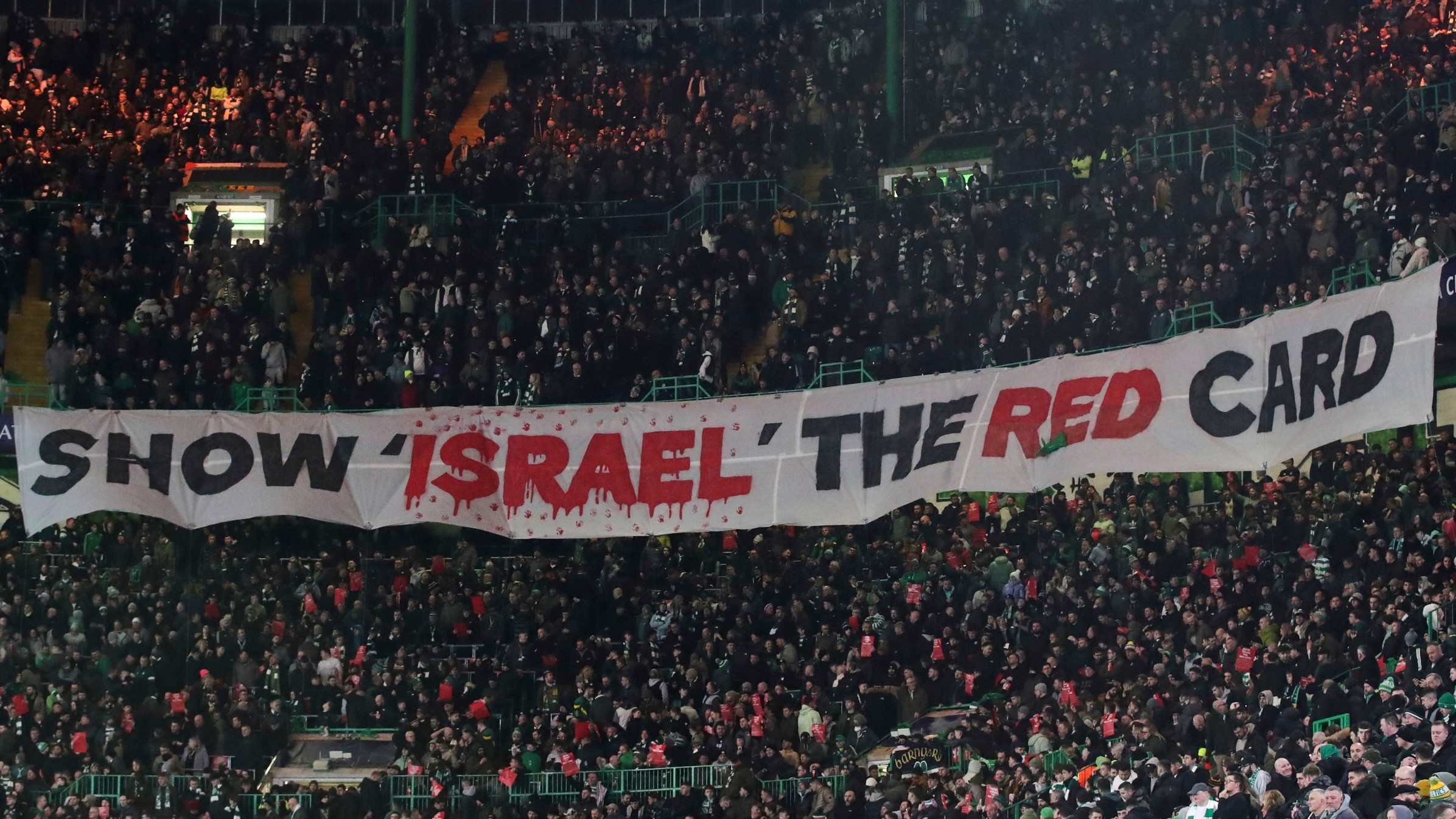 FILE - Celtic fans lift a protest banner about Israel during the Champions League playoff match between Glasgow Celtic and Bayern Munich in Glasgow, Scotland, Feb. 12, 2025.