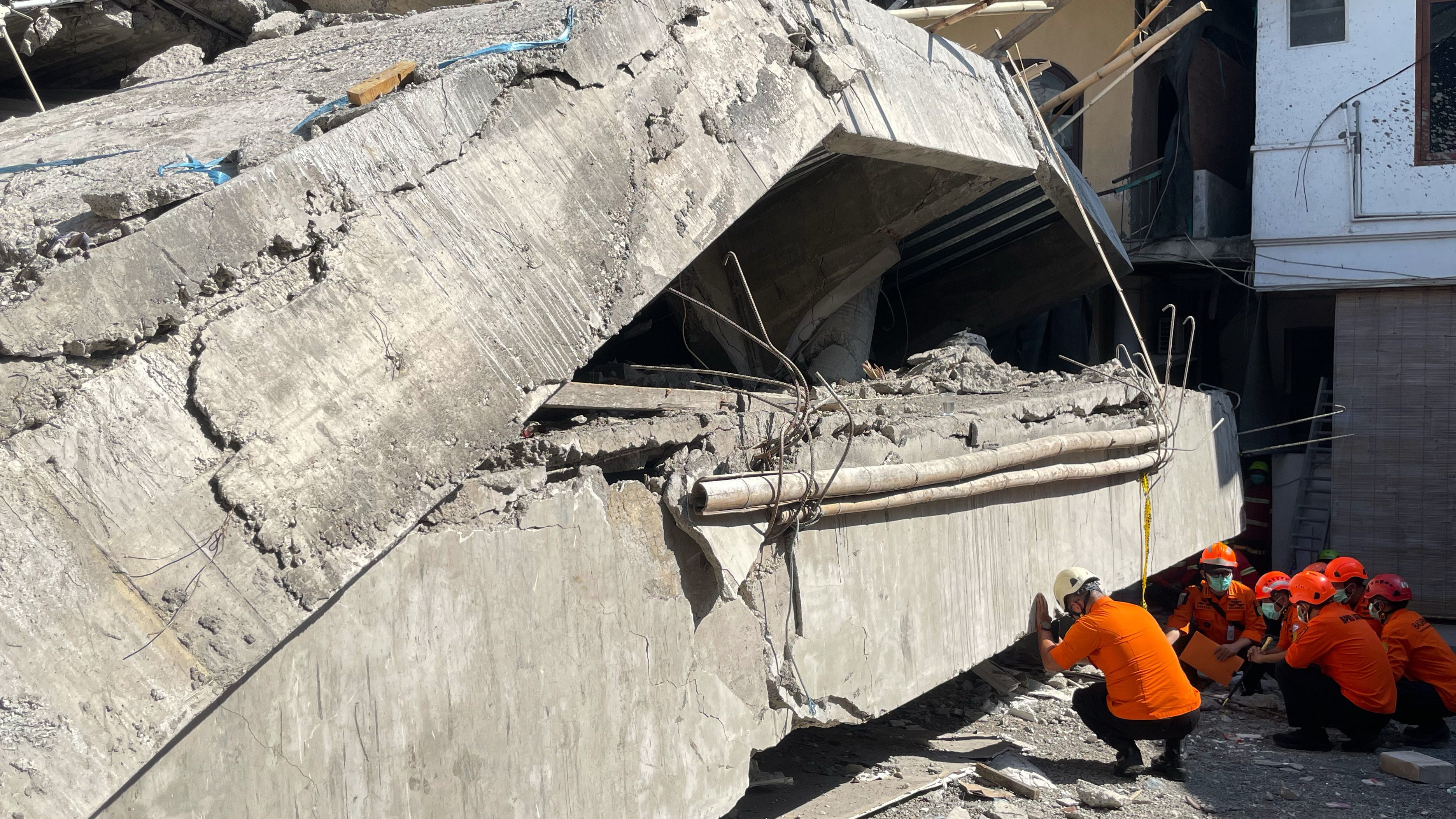 Rescuers search for victims after a building under construction collapsed, at an Islamic boarding school in Sidoarjo, East Java, Indonesia, Wednesday, Oct. 1, 2025.