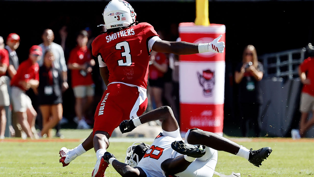NC State's Hollywood Smothers breaks the tackle of Campbell's Jojo Pace on his way to a touchdown on Saturday in Raleigh.