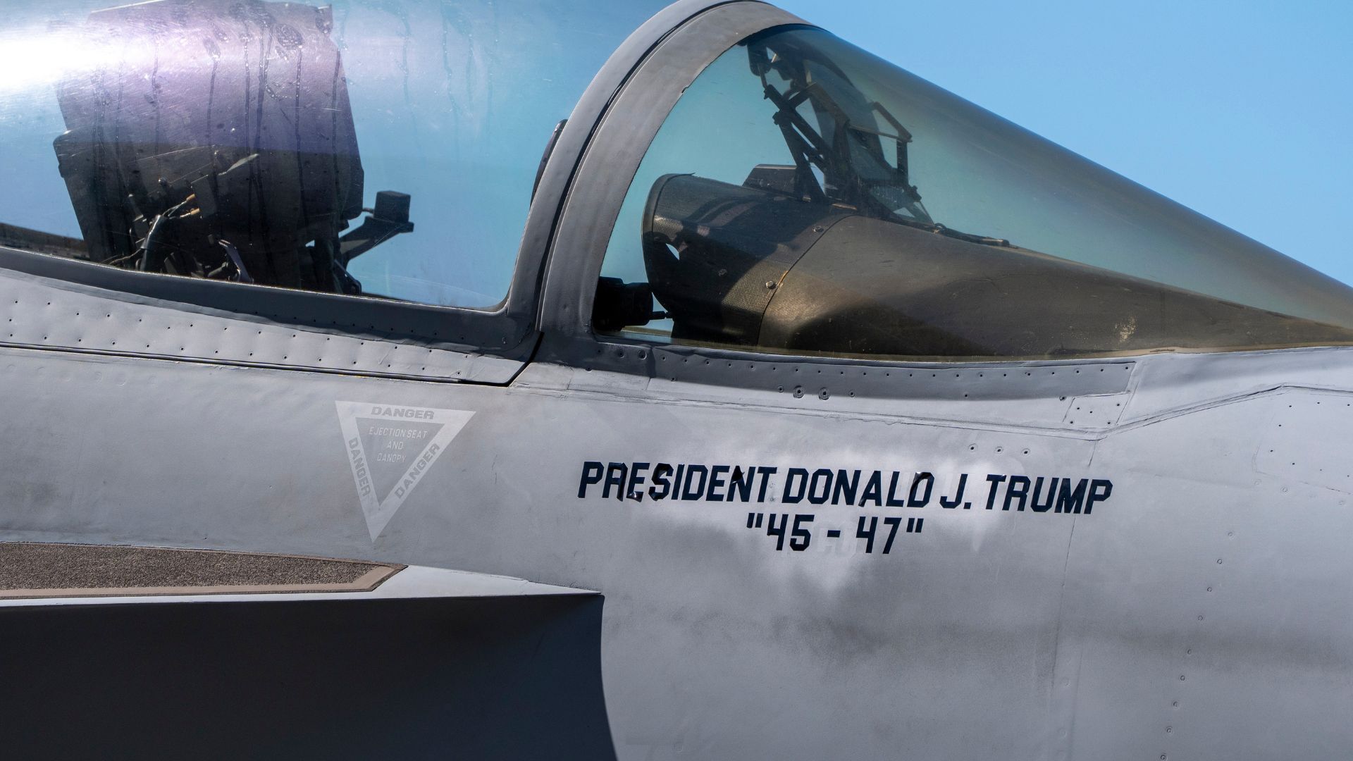 An F/A-18E fighter jet with Trump's name stenciled onto is seen aboard the USS George H.W. Bush aircraft carrier off the coast of Norfolk, Va., Saturday, Oct. 4, 2025.