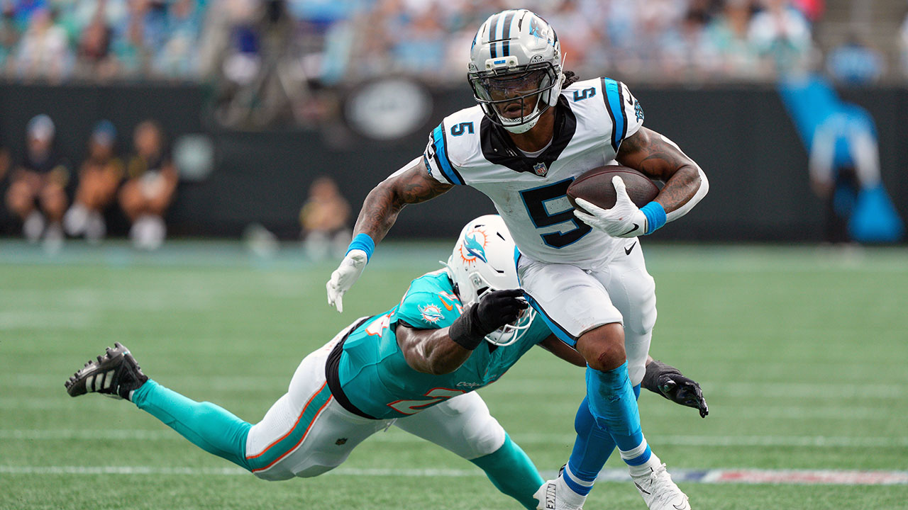 Panthers running back Rico Dowdle runs past Miami Dolphins linebacker Tyrel Dodson on Sunday in Charlotte.