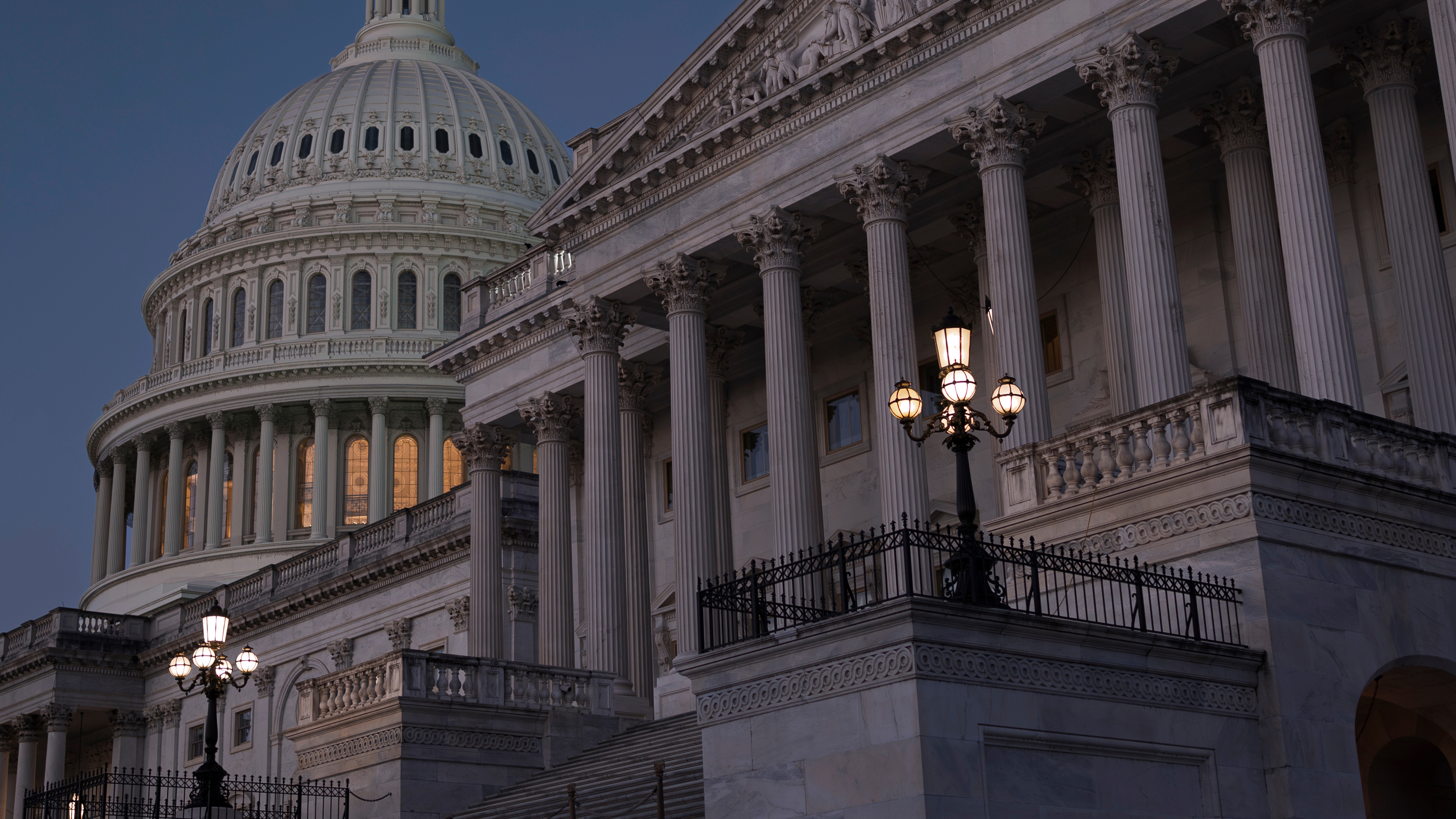 The Senate side of the Capitol is illuminated at dawn on the 6th day of the government shutdown, in Washington, Monday, Oct. 6, 2025. 
