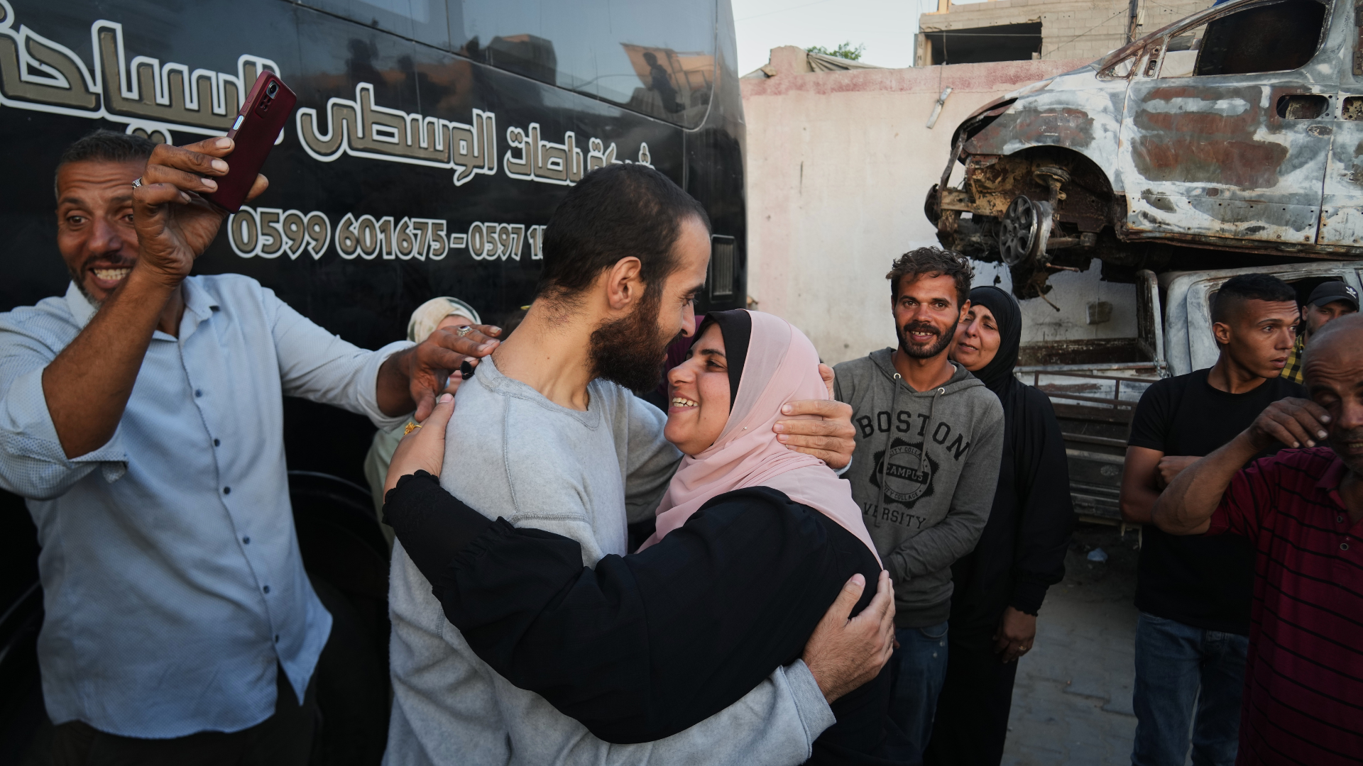 People greet freed Palestinian prisoners as they arrive in the Gaza Strip after their release from Israeli jails under a ceasefire agreement between Hamas and Israel, outside Nasser Hospital in Khan Younis, southern Gaza Strip, Monday, Oct. 13, 2025.