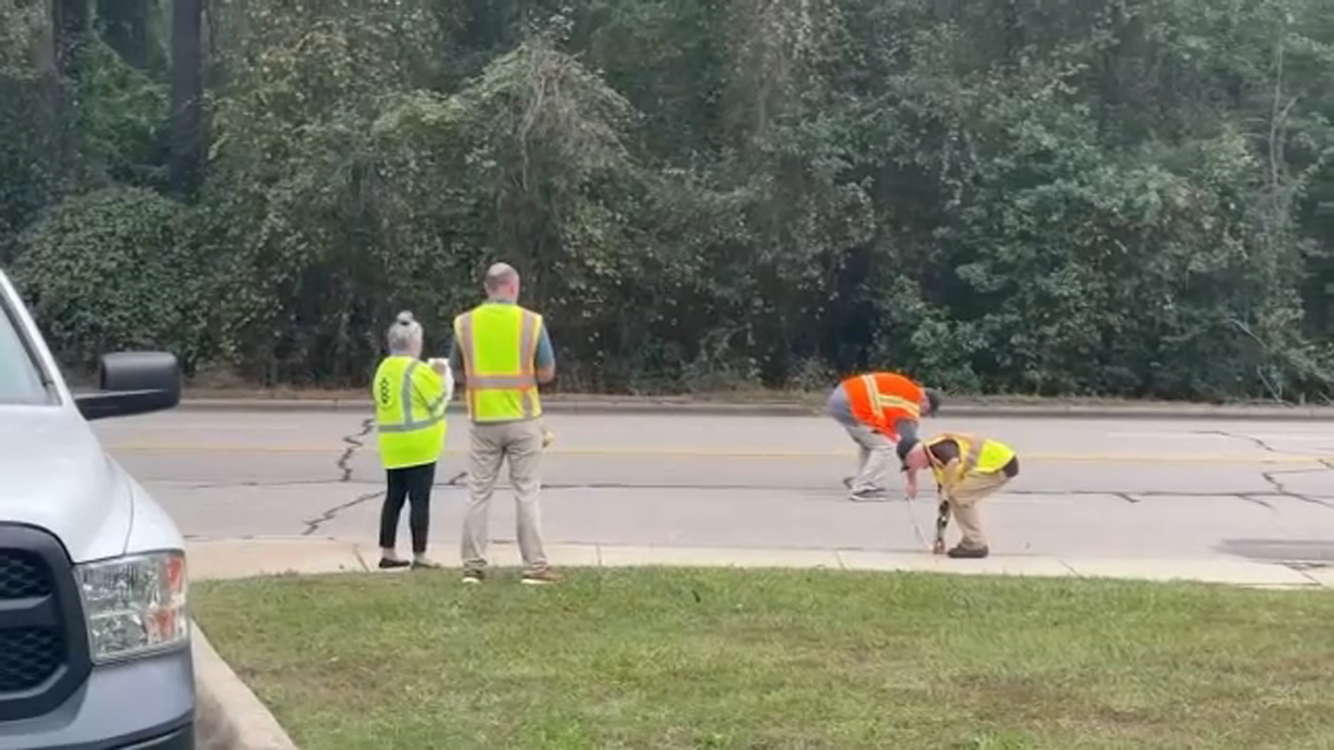 Crews take measurements as a study of Rosehill Road gets underway Monday.