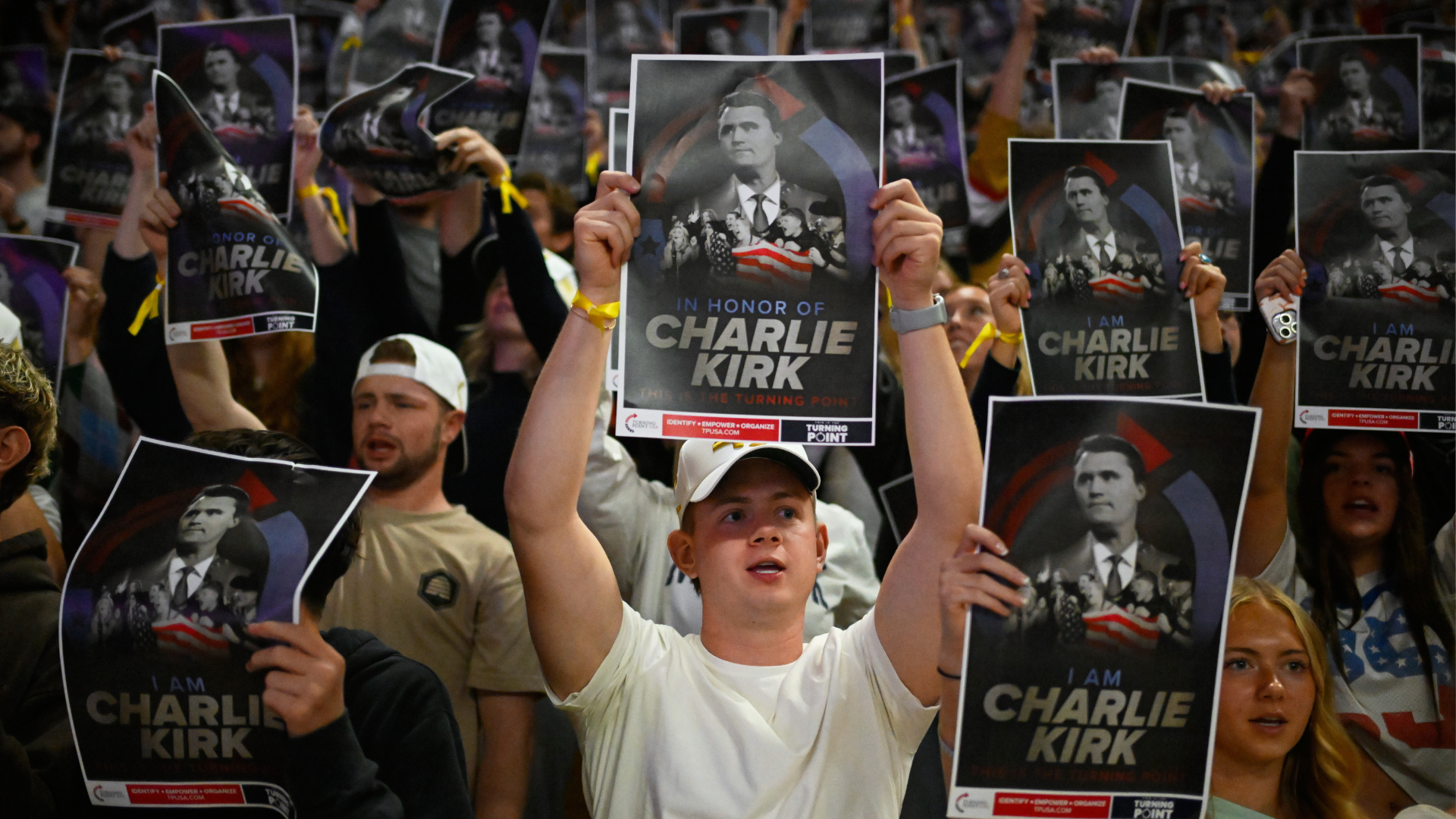 People carry posters of Charlie Kirk during a Turning Point USA march at Utah State University, as part of the organization's campaign to memorialize Kirk, Tuesday, Sept. 30, 2025, in Logan, Utah.