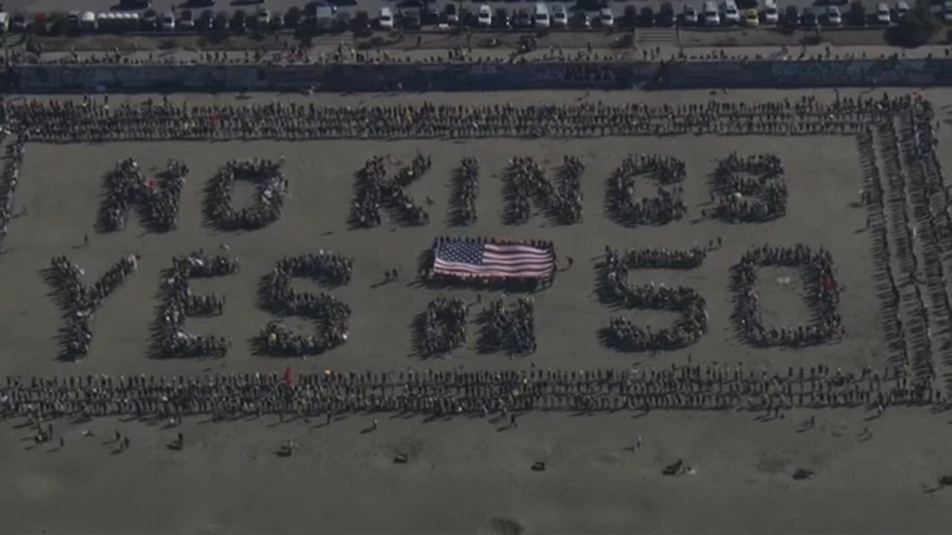 SKY7 is over No Kings protesters forming a human banner at San Francisco's Ocean Beach on Saturday, Oct. 18, 2025.