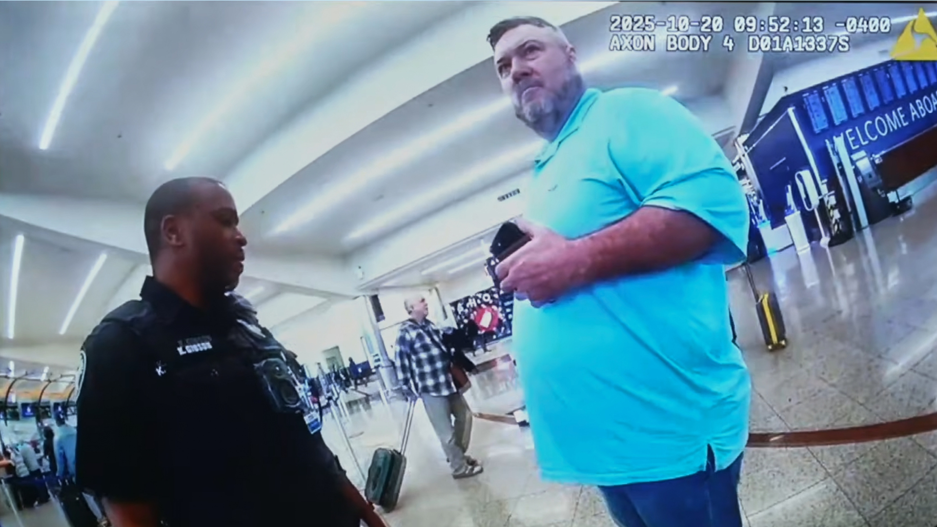 This image from an Oct. 20, 2025, police body camera footage shows Billy Joe Cagle, of Cartersville, Ga., right, talks to police officers before he was arrested inside the domestic terminal at Hartsfield-Jackson Atlanta International Airport in Atlanta.