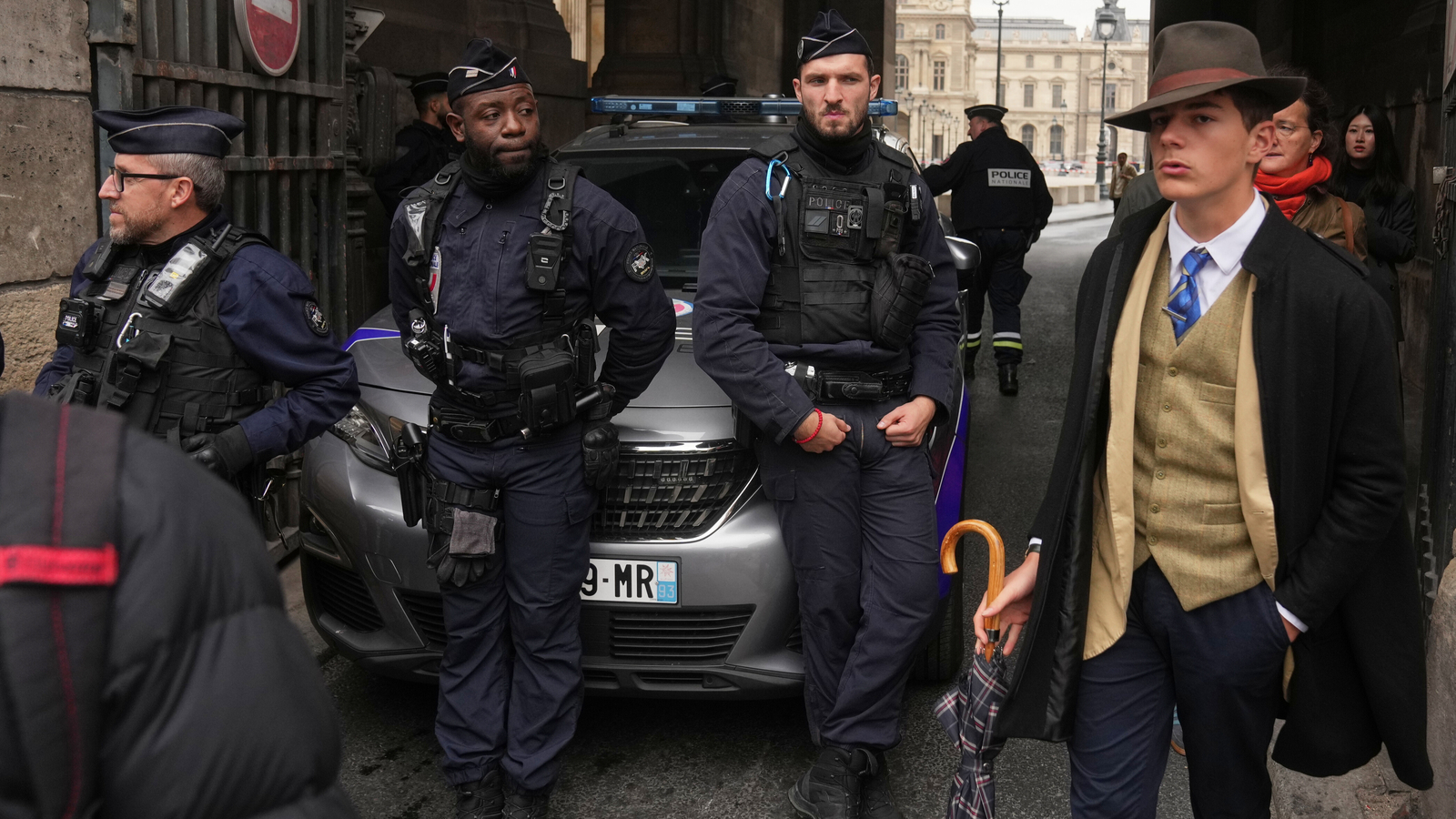 Inspector Clouseau? The mystery man in an AP photo after the Louvre jewel heist creates a buzz