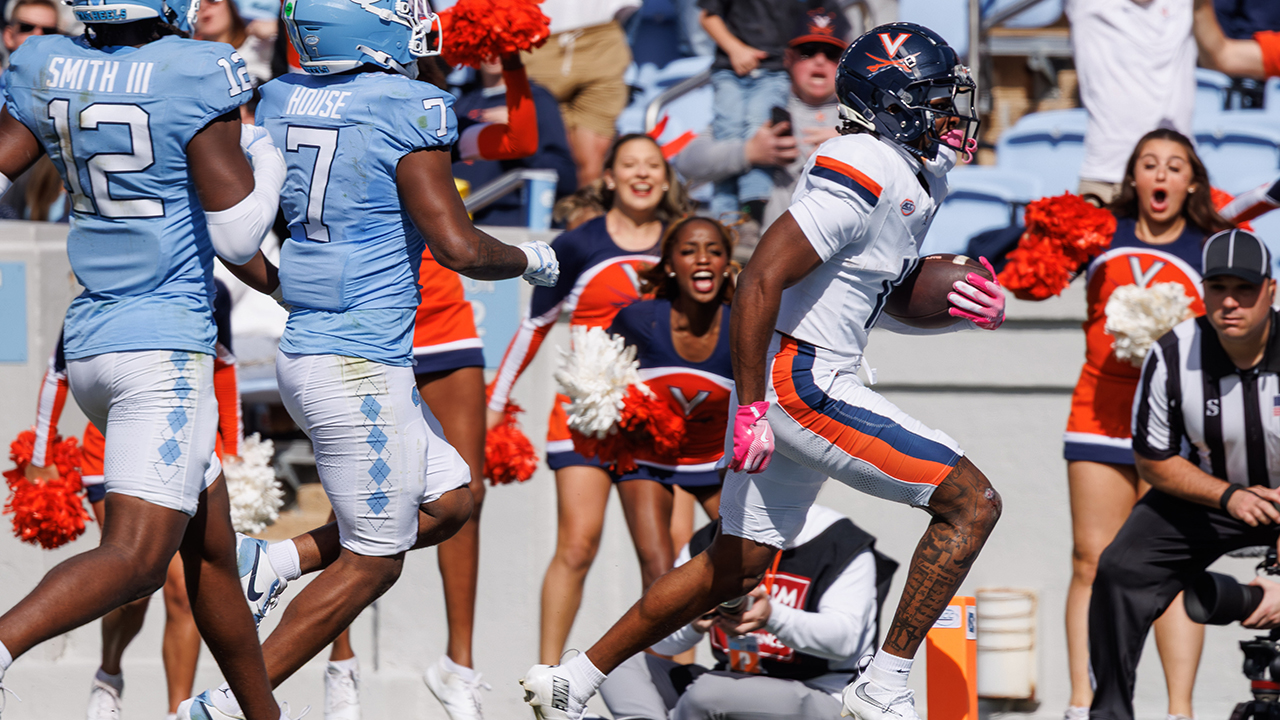 Virginia's Trell Harris scores a touchdown ahead of North Carolina's Khmori House and Greg Smith on Saturday in Chapel Hill.