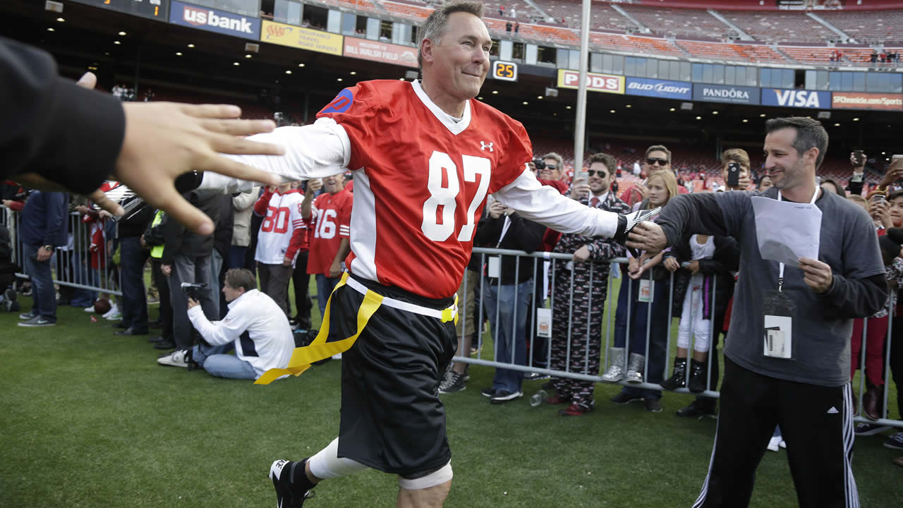 Former San Francisco 49ers' Dwight Clark runs onto the field before the start of the "Legends of Candlestick" flag football game July 12, 2014, in San Francisco. (AP Photo)