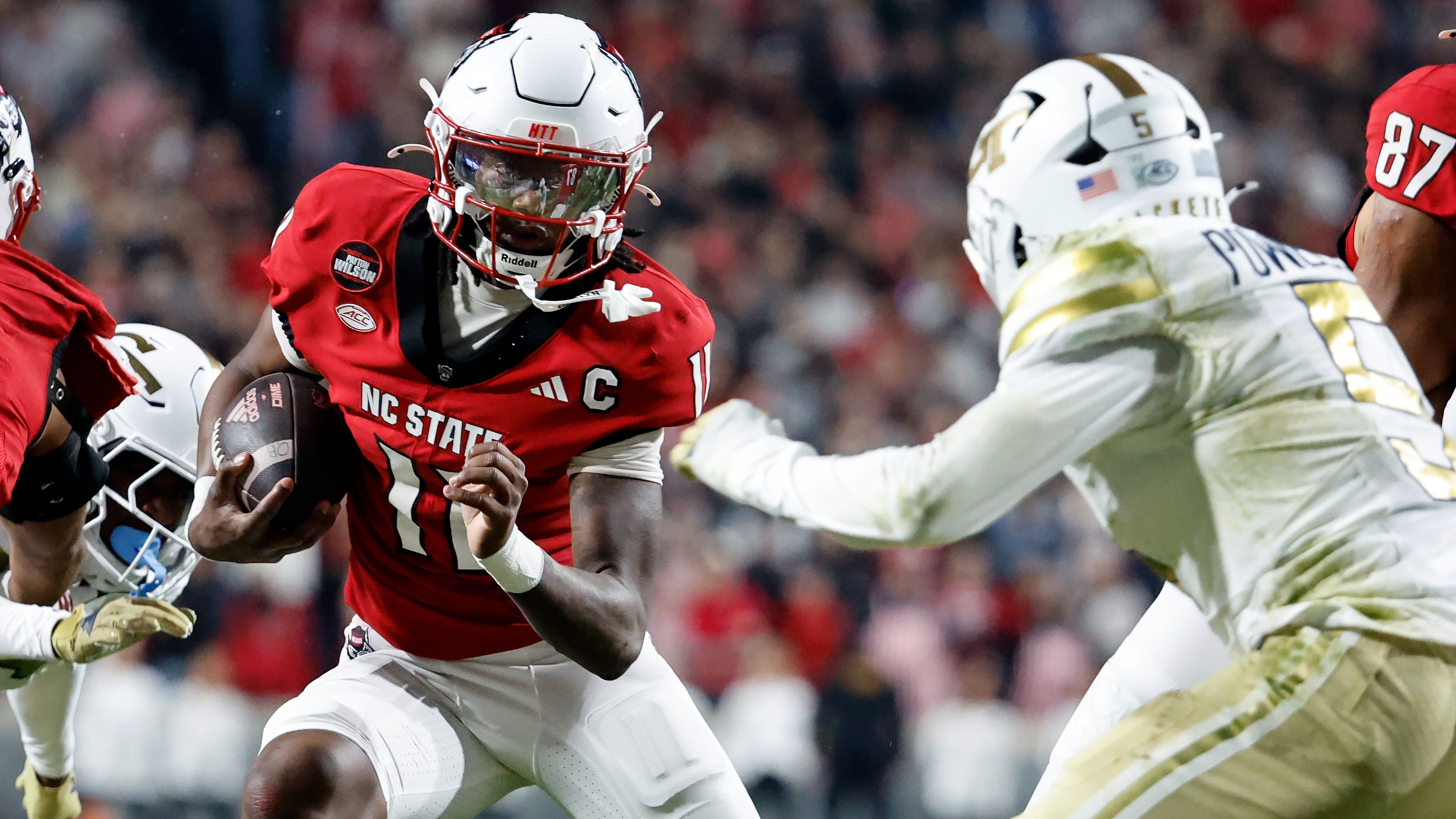 NCSU QB CJ Bailey runs the ball as Georgia Tech's Clayton Powell-Lee closes in during their game in Raleigh, N.C., Saturday, Nov. 1, 2025. (AP Photo/Karl DeBlaker)