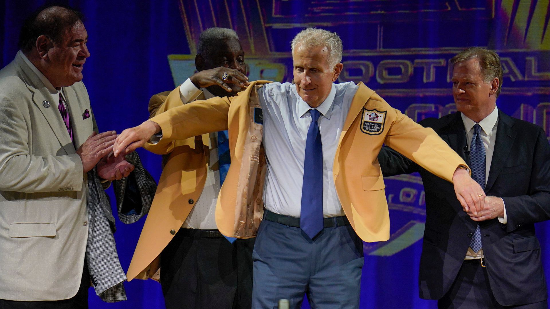 Paul Tagliabue, a member of the Pro Football Hall of Fame Centennial Class, receives his gold jacket during the gold jacket dinner in Canton, Ohio, Aug. 6, 2021.