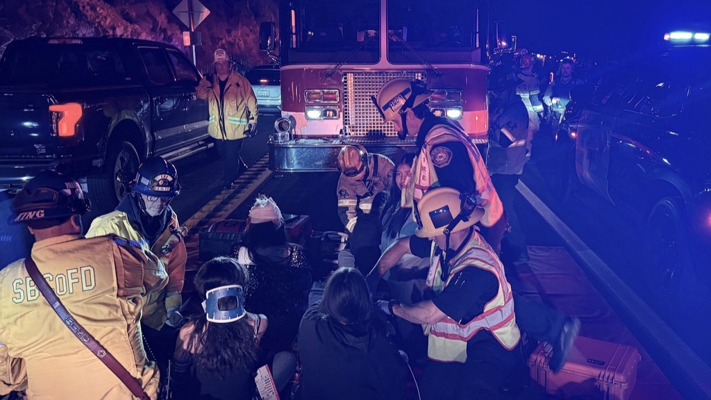 This image provided by San Bernardino County Fire shows the scene on a highway near Running Springs, Calif., where a bus overturned on Sunday, Nov. 9, 2025.