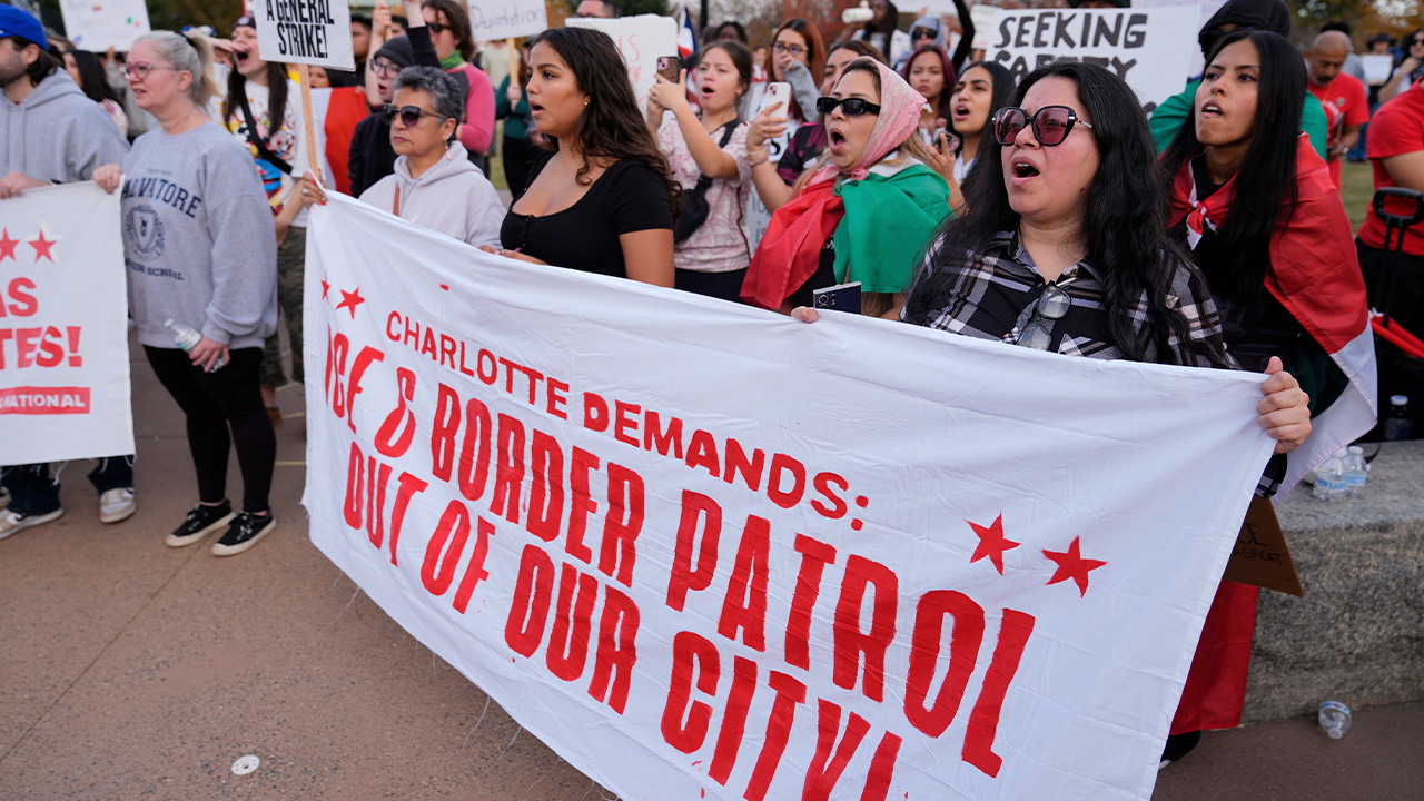 People protest against federal immigration enforcement Saturday, Nov. 15, 2025, in Charlotte, N.C.