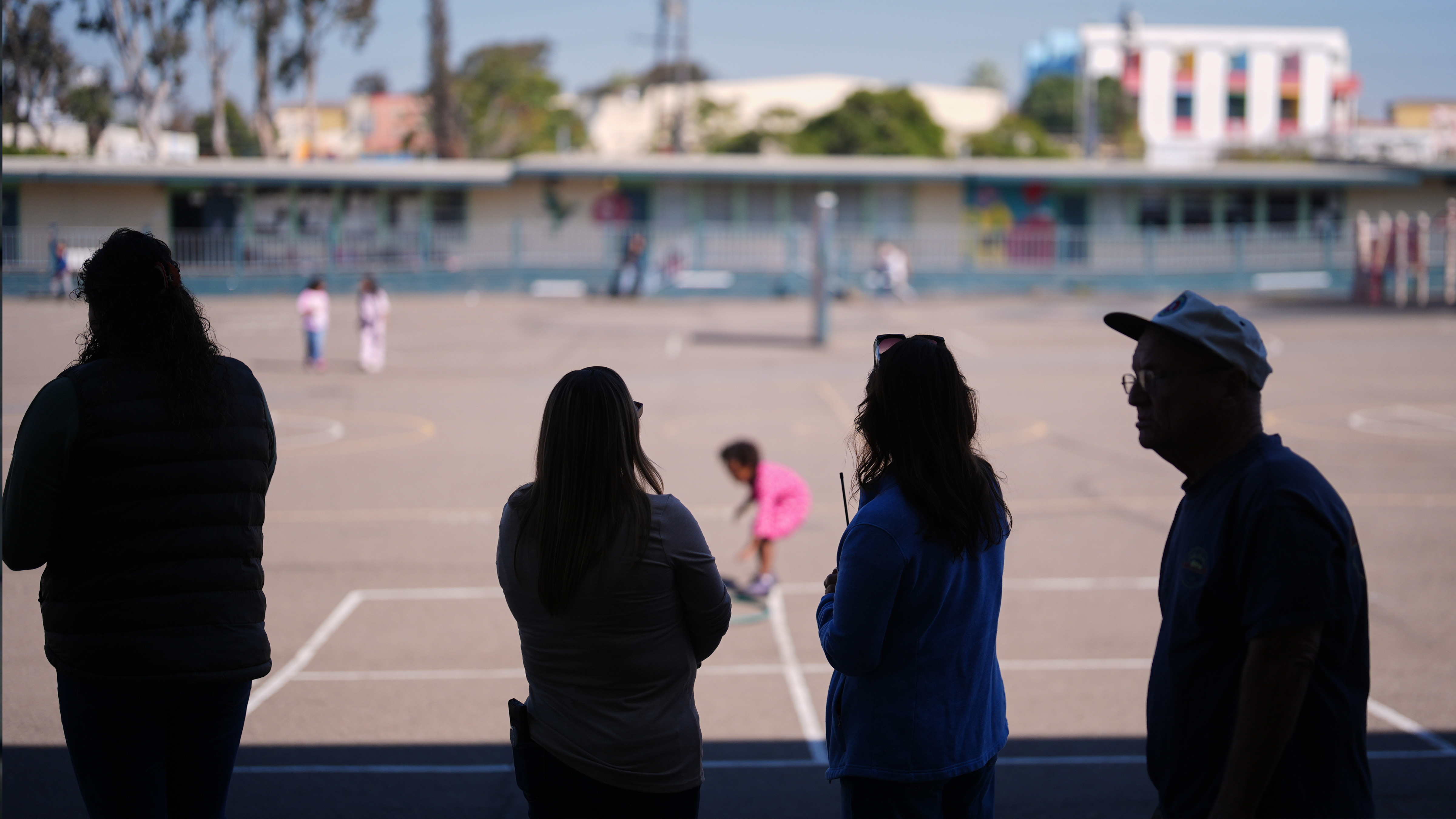 Teachers look on as students play on the playground at Perkins K-8 School Thursday, Nov. 13, 2025, in San Diego.