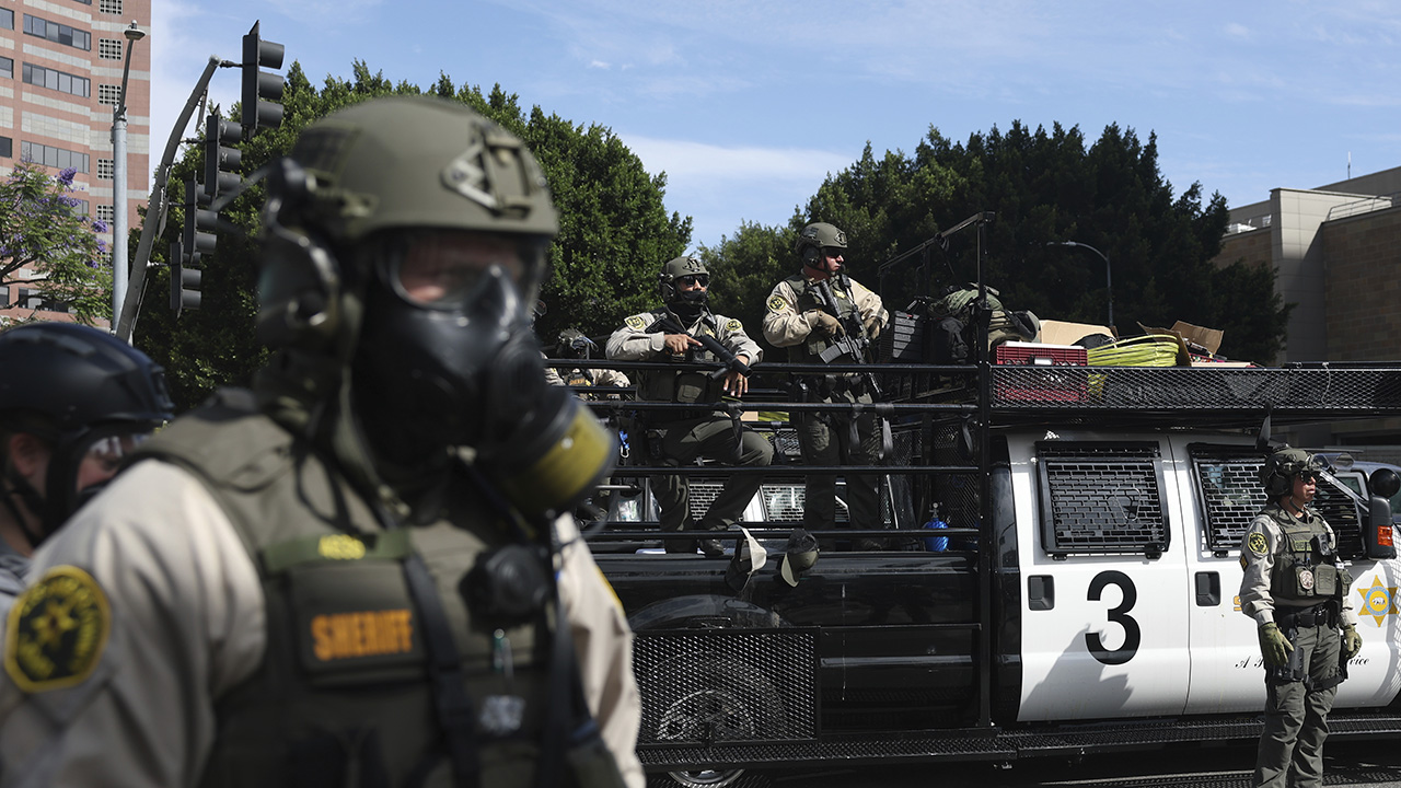 Trump sues CA over law banning masked federal agents