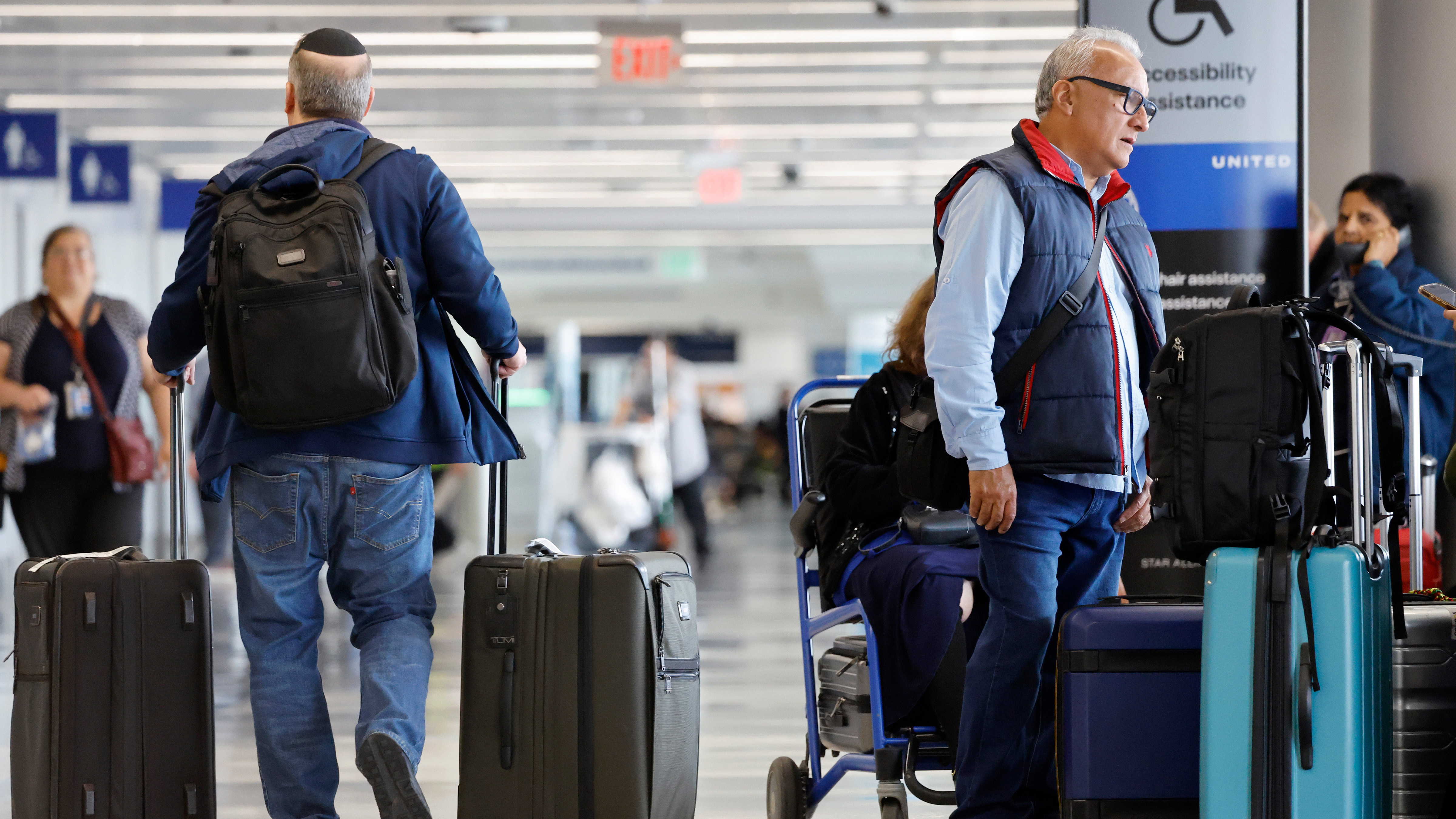 Travelers gather with their luggage near the United Airlines check-in area at Los Angeles International Airport (LAX) on November 12, 2025 in Los Angeles, California.