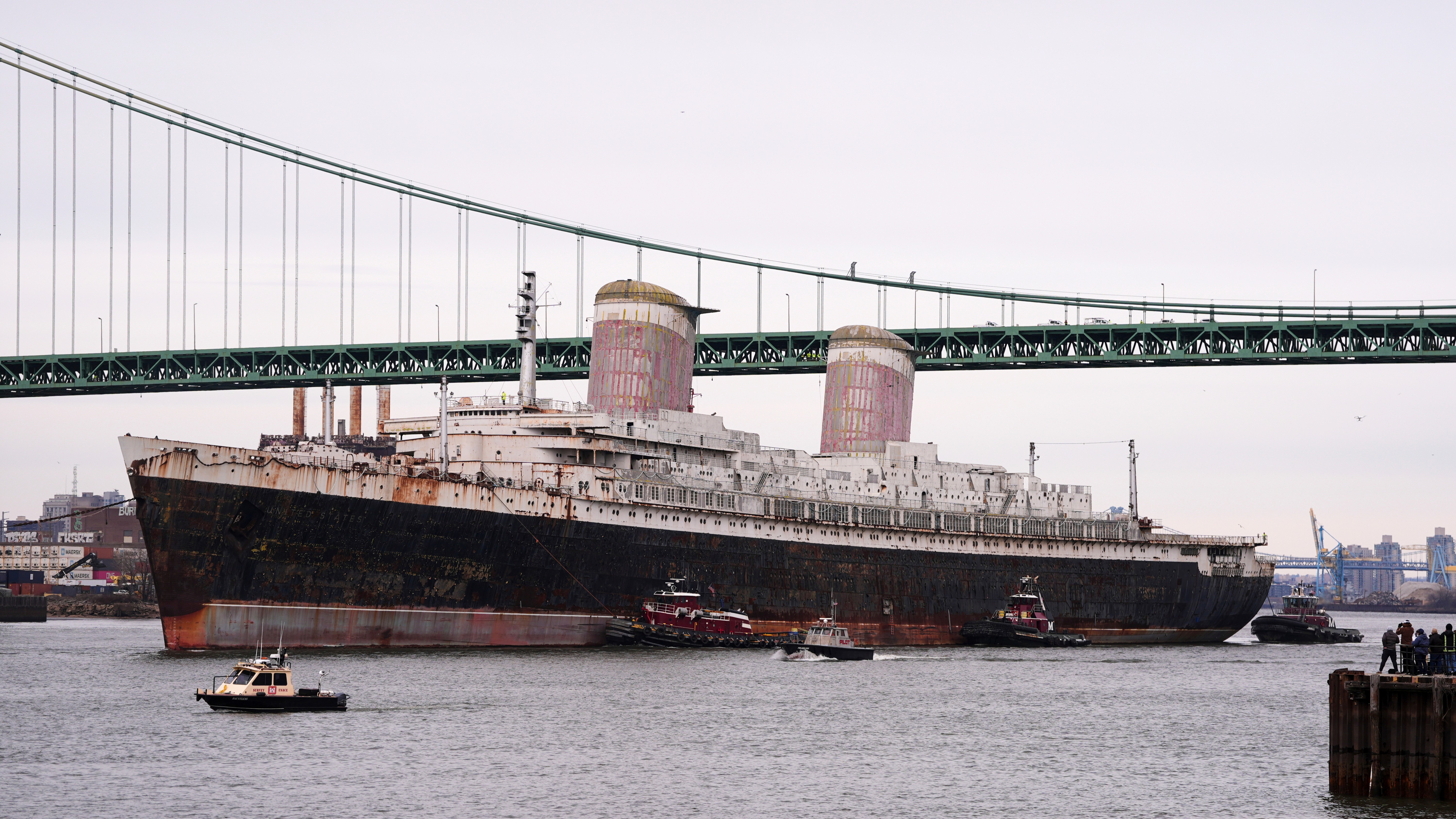 The SS United States is towed down the Delaware River between Pennsylvania and New Jersey, from Philadelphia, Wednesday, Feb. 19, 2025.