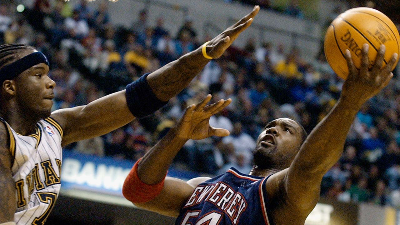 New Jersey Nets forward Rodney Rogers puts up a shot against Indiana Pacers forward Jermaine O'Neal during a game in Indianapolis on April 9, 2004.