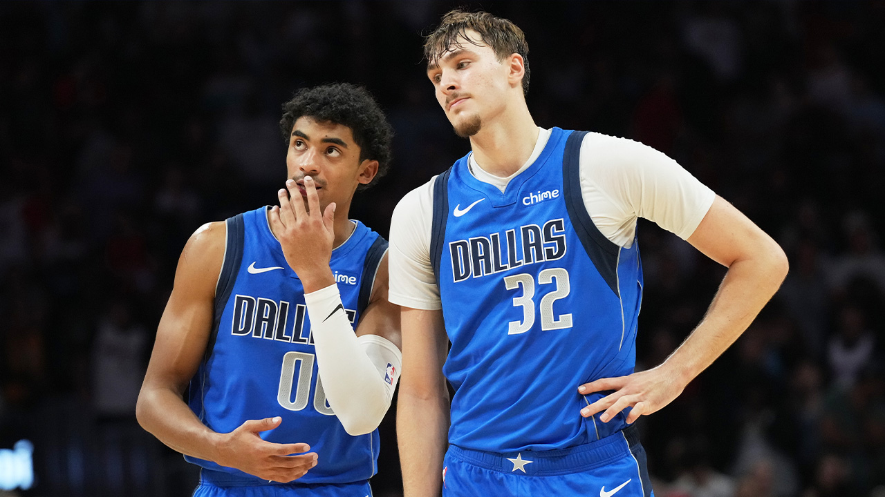 Mavs guard Max Christie (00) and forward Cooper Flagg (32) stand together during NBA basketball game against the Miami Heat Monday, Nov. 24, 2025, in Miami.