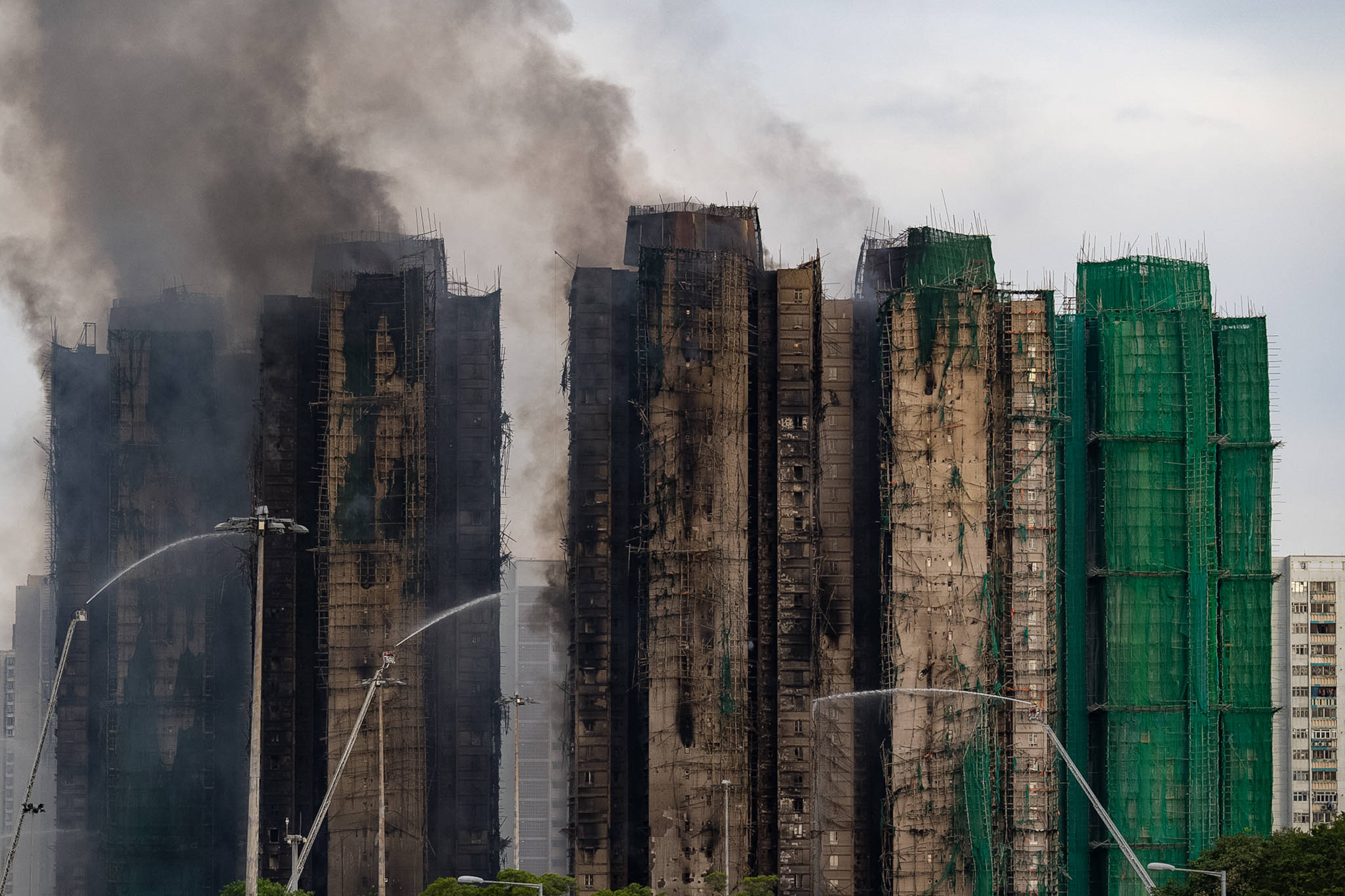 Firefighters work to extinguish a fire which broke out Wednesday at Wang Fuk Court, a residential estate in the Tai Po district of Hong Kong's New Territories, Nov. 27, 2025.