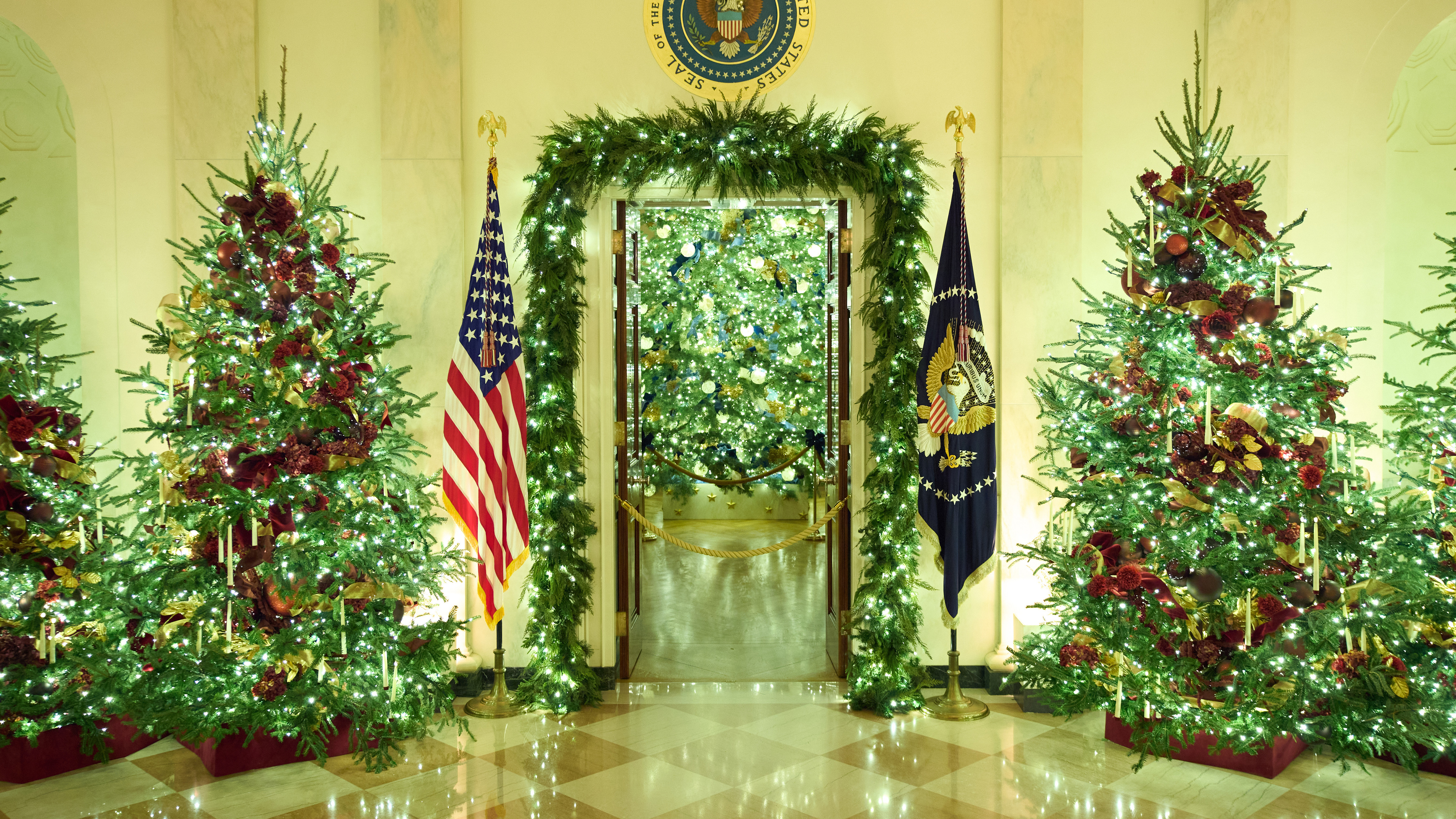 Christmas trees decorate the Cross Hall of the White House during a press preview of the Christmas decorations "Home is Where the Heart Is," Monday, Dec. 1, 2025, in Washington.