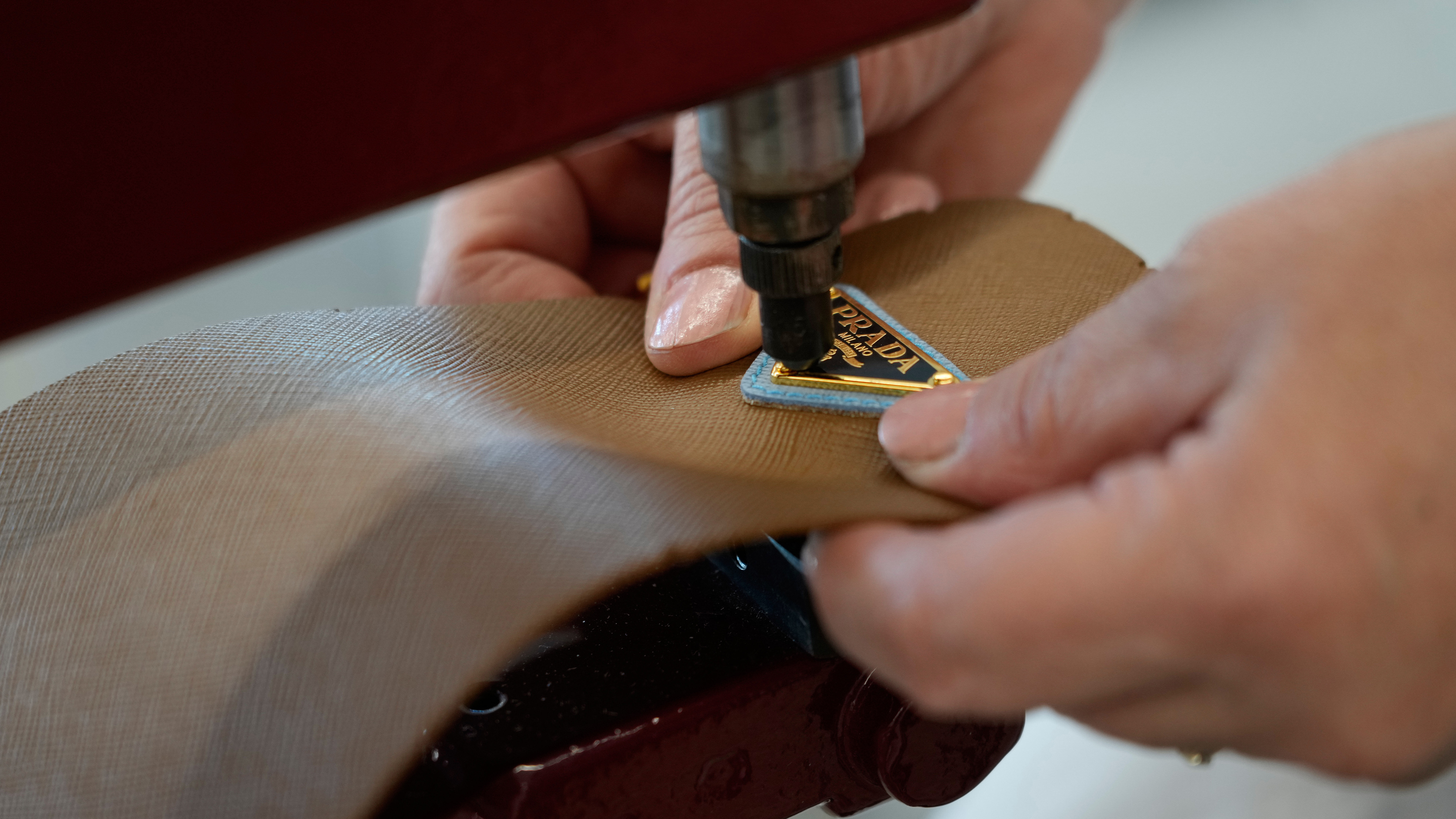 A leather good operator works at the Prada factory in Scandicci, Italy, Friday, Nov. 28, 2025.