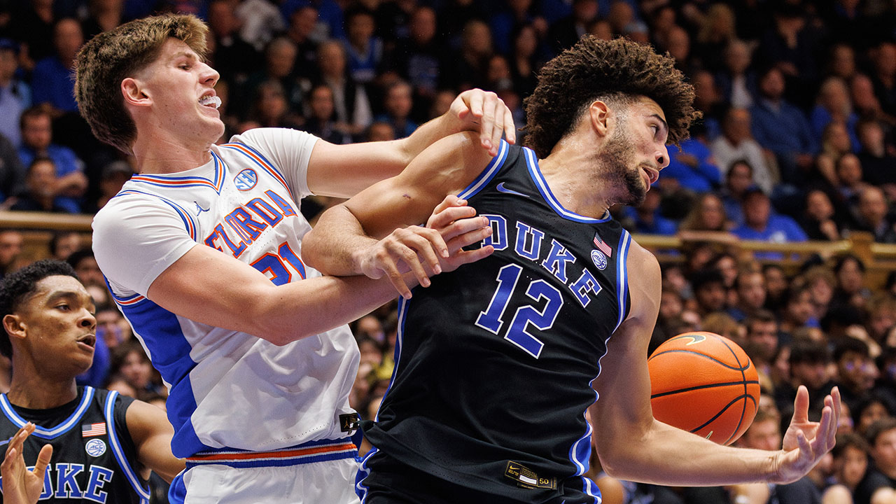 Duke's Cameron Boozer (12) battles for a loose ball with Florida's Alex Condon on Tuesday night in Durham.