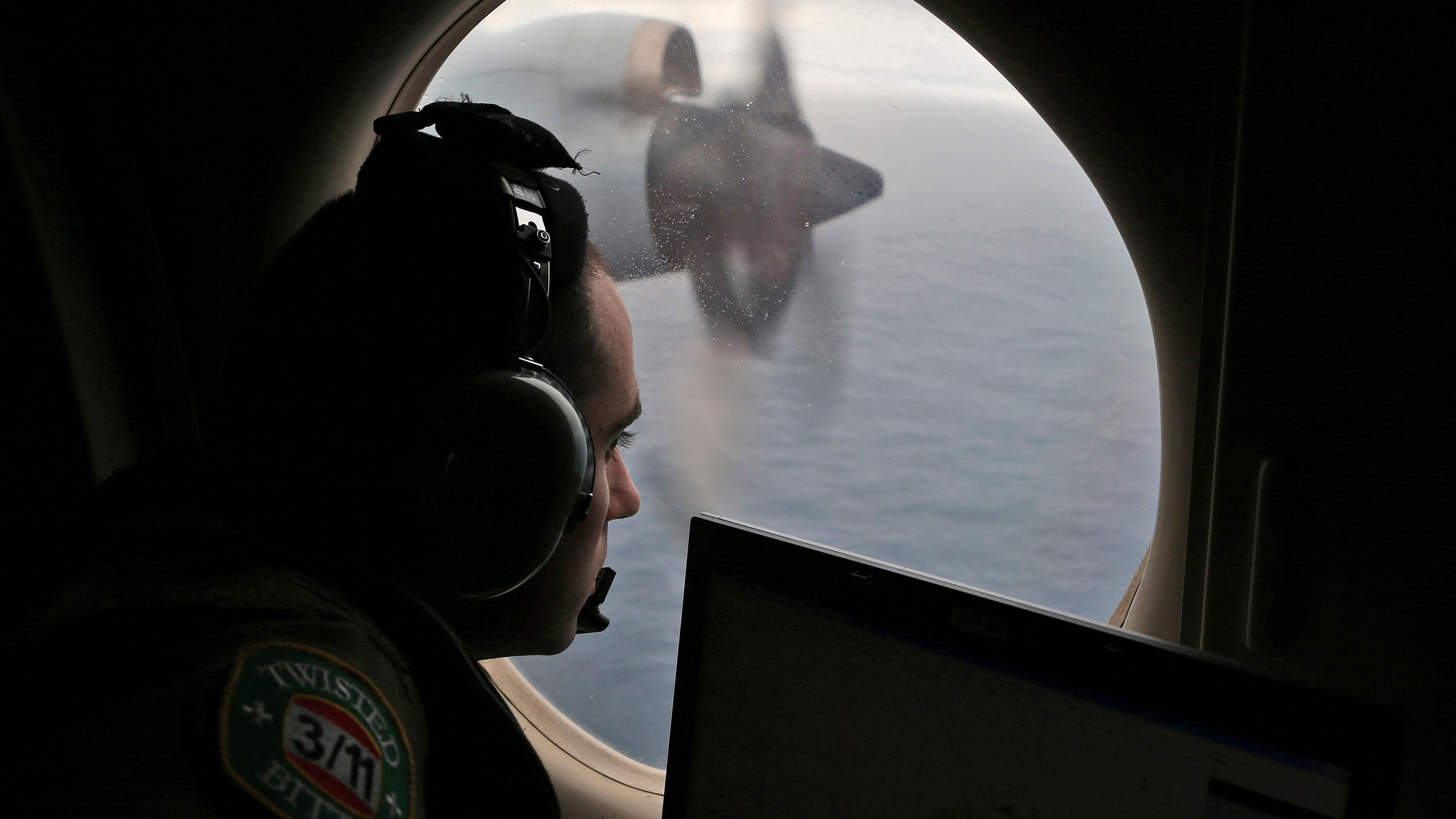 Flight officer Rayan Gharazeddine scans the water in the southern Indian Ocean off Australia from a Royal Australian Air Force AP-3C Orion during a search for the missing Malaysia Airlines Flight MH370 on March 22, 2014.