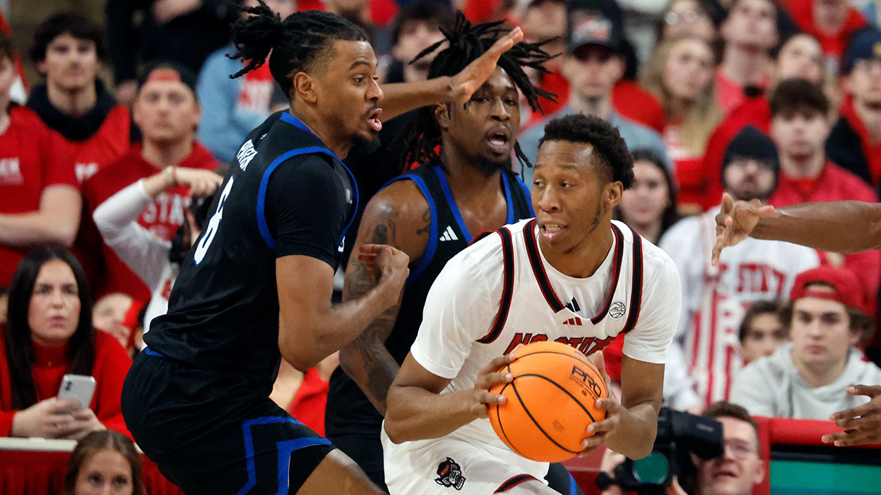 NC State's Quadir Copeland looks to pass against North Carolina-Asheville's DJ Patrick on Saturday in Raleigh.
