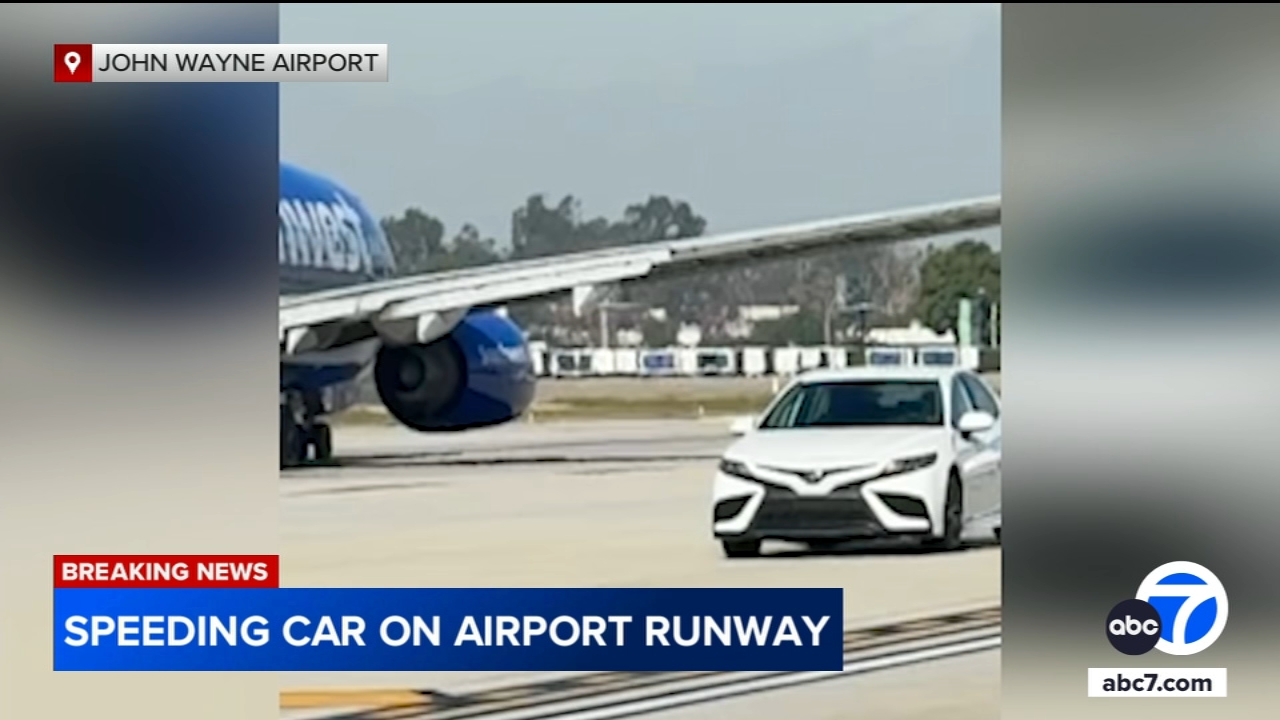 Car speeds past several planes on taxiway at California airport, video shows