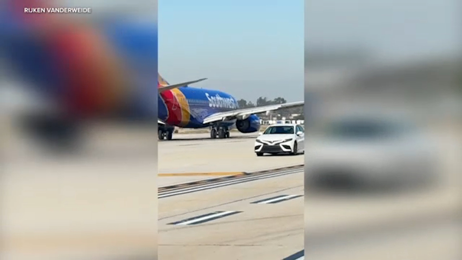 Car speeds past several planes on taxiway at California airport, video shows