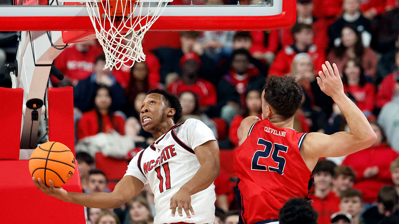 NC State's Quadir Copeland drives the ball past Liberty's Zach Cleveland on Wednesday night in Raleigh