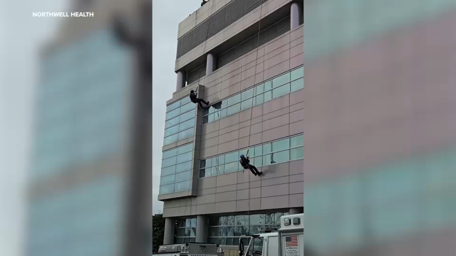 Police officers rappel off roof of Long Island medical center to deliver holiday gifts to children