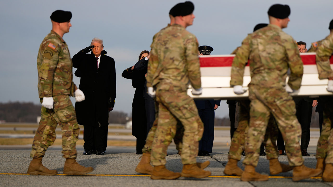 President Donald Trump salutes as carry teams move the remains of Sgt. Edgar Brian Torres-Tovar, 25, of Des Moines, Iowa, on Wednesday at Dover Air Force Base, Del.