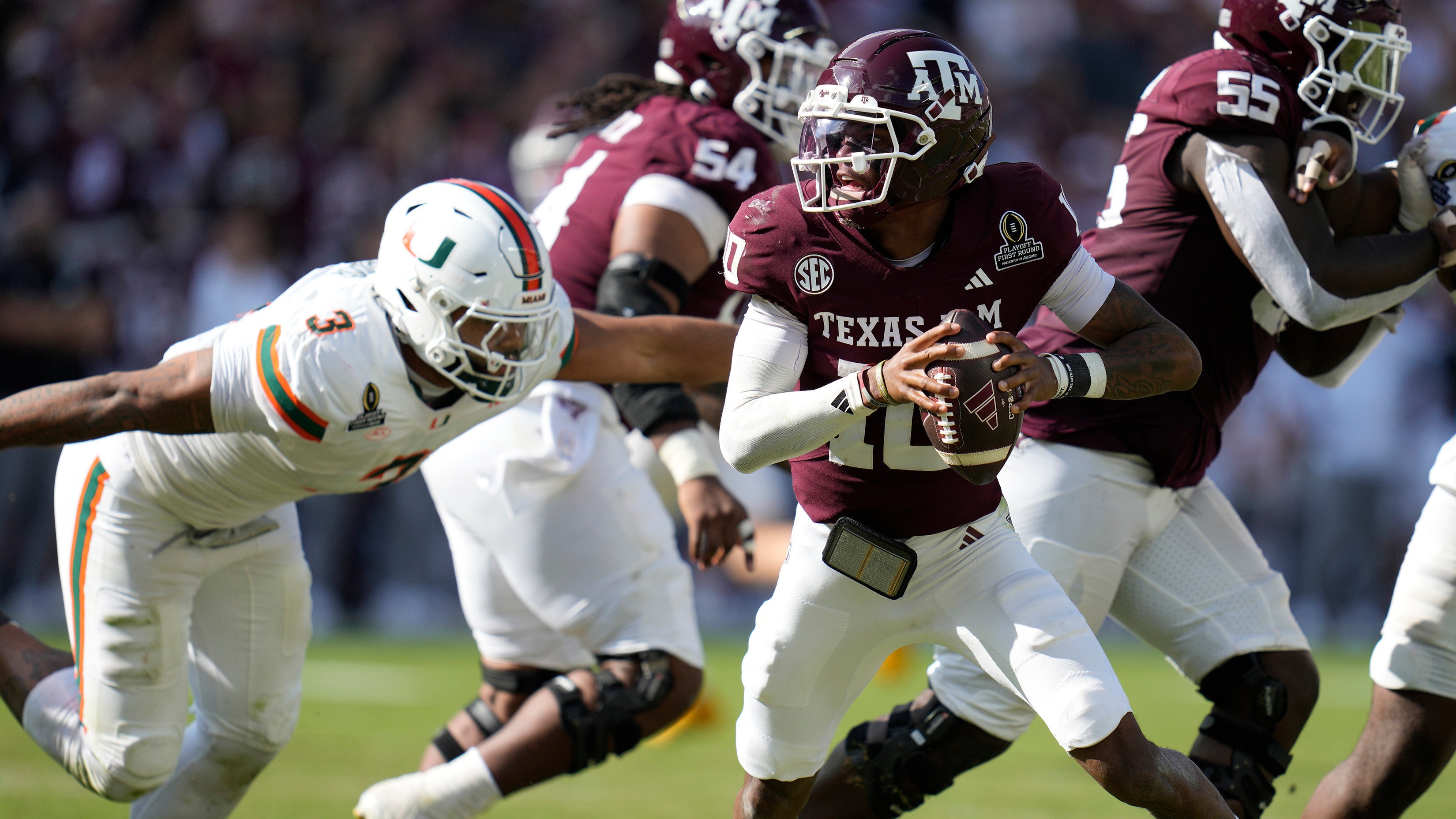 Texas A&M QB Marcel Reed scrambles before being sacked by Miami DE Akheem Mesidor during the first round of the NCAA College Football Playoff, in College Station, Texas.