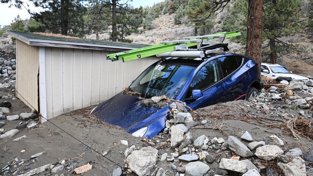 A car is buried in mud after a series of storms Thursday, Dec. 25, 2025, in Wrightwood, Calif.
