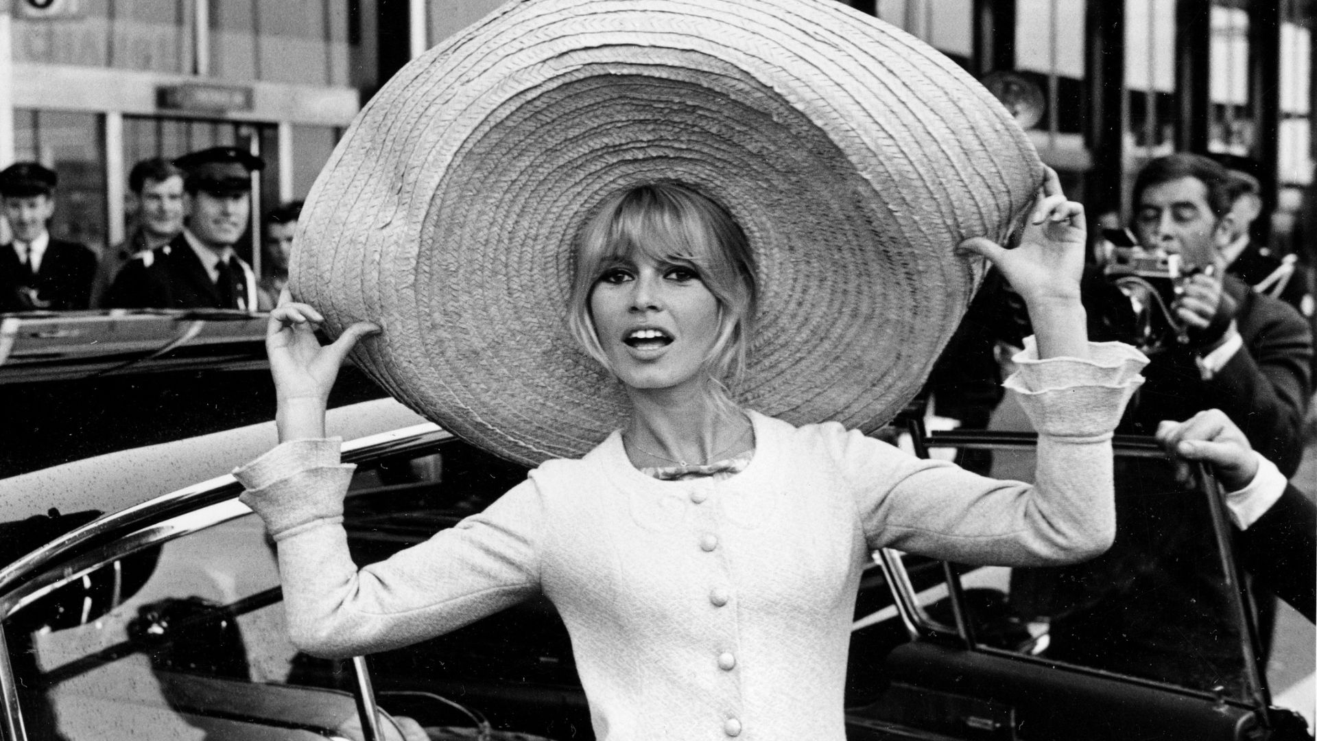 FILE - French actress Brigitte Bardot poses with a huge sombrero she brought back from Mexico, as she arrives at Orly Airport in Paris, France, on May 27, 1965.