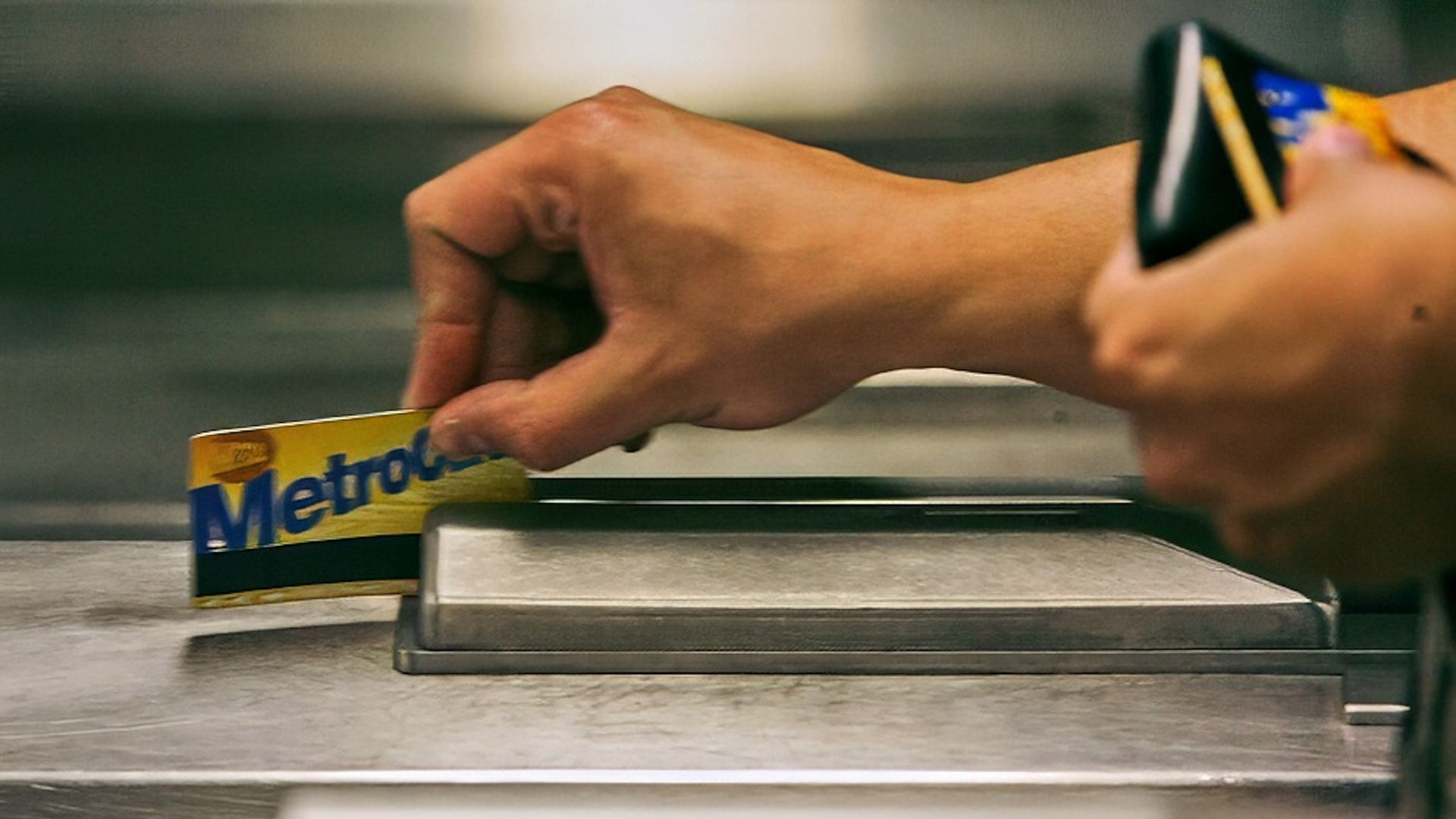A subway rider swipes his MetroCard in a turnstile as he enters the 34th St. subway station, July 23, 2007, in New York.