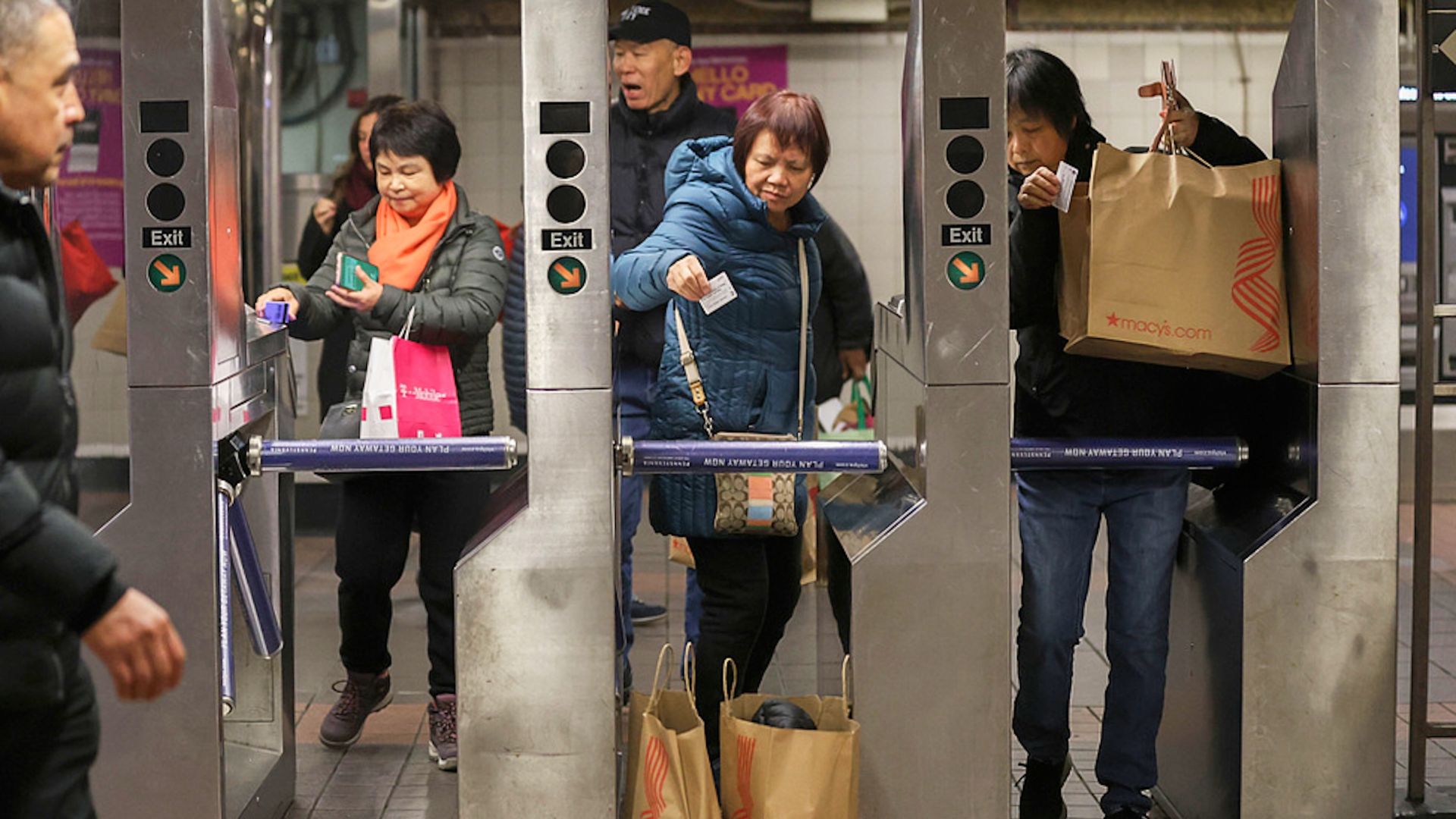 Shoppers swipe their MetroCards as they enter the subway turnstiles, Nov. 29, 2024, in New York.